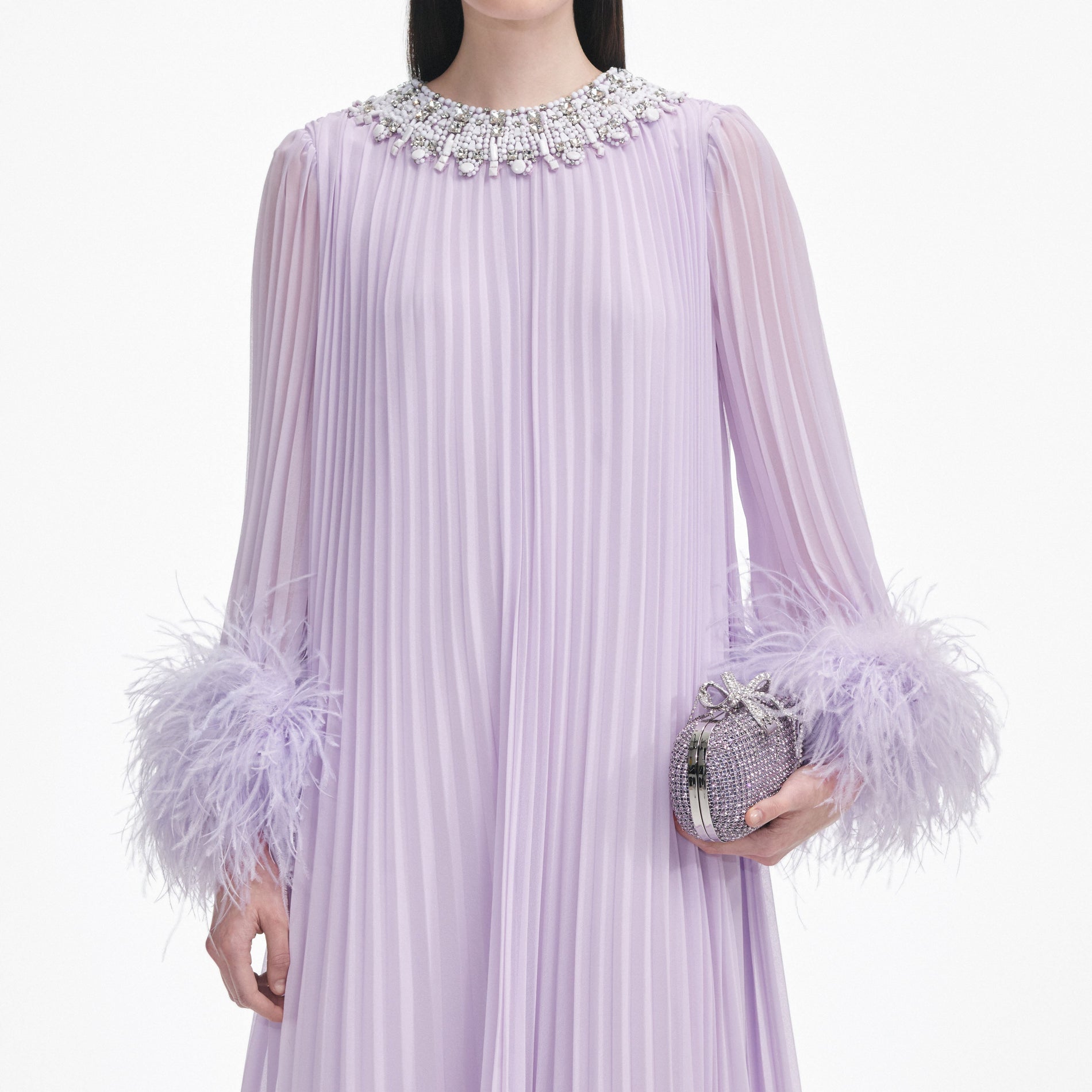 A close up of a woman wearing the Lilac Chiffon Feather Midi Dress
