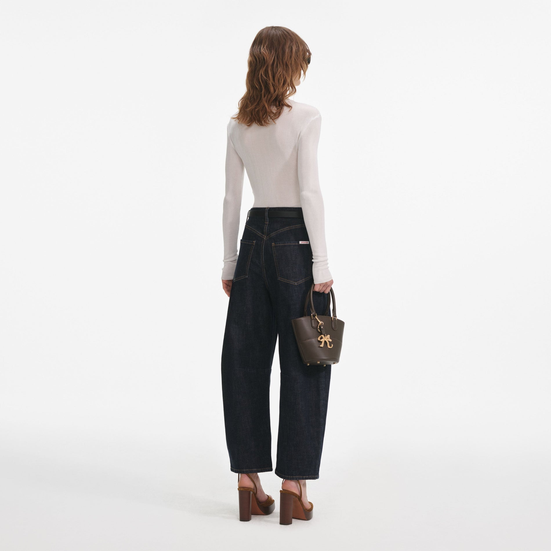 Back view of a woman wearing the White Viscose Knit Bodysuit