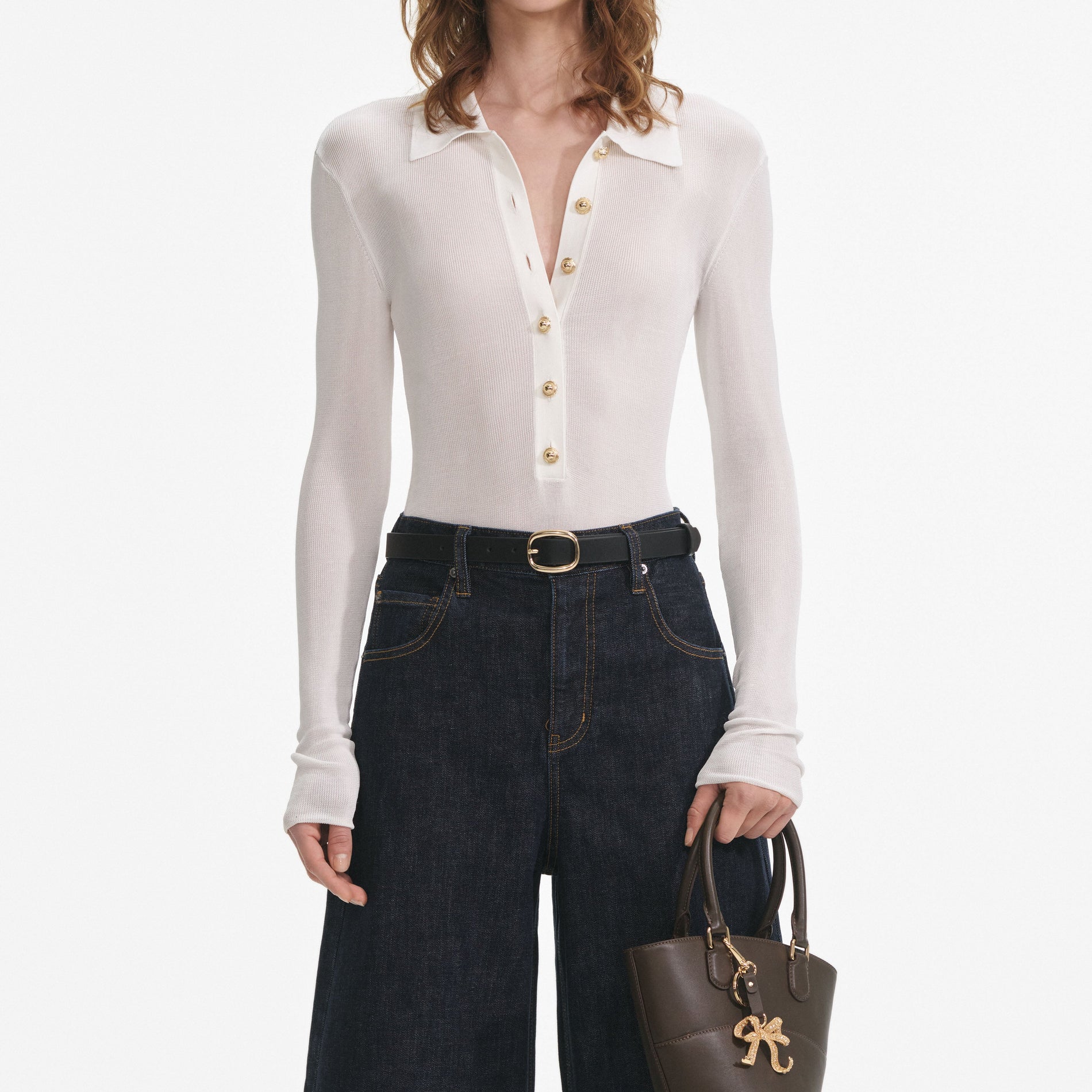 A close up of a woman wearing the White Viscose Knit Bodysuit