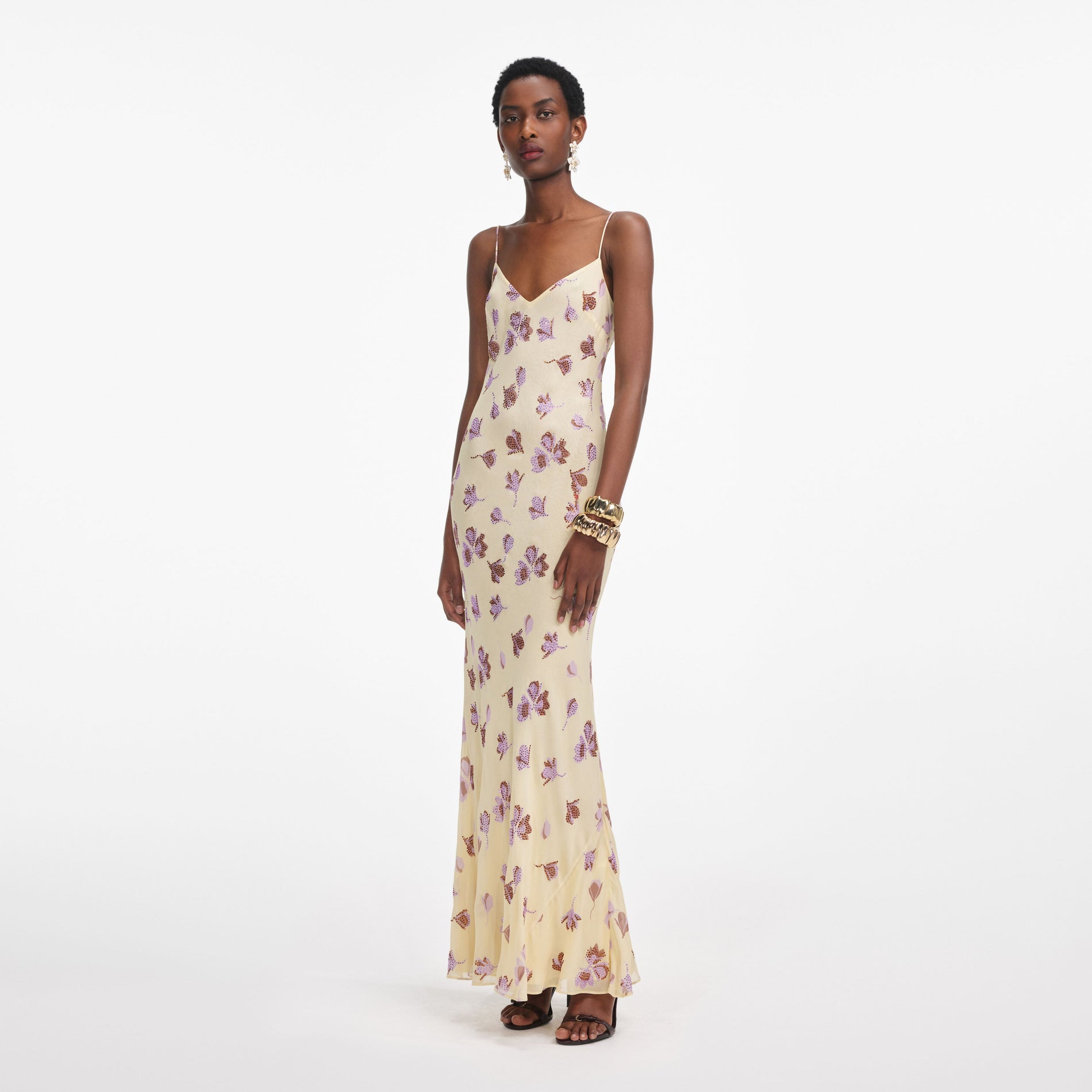 Side view of a woman wearing the Yellow Floral Rhinestone Maxi Dress