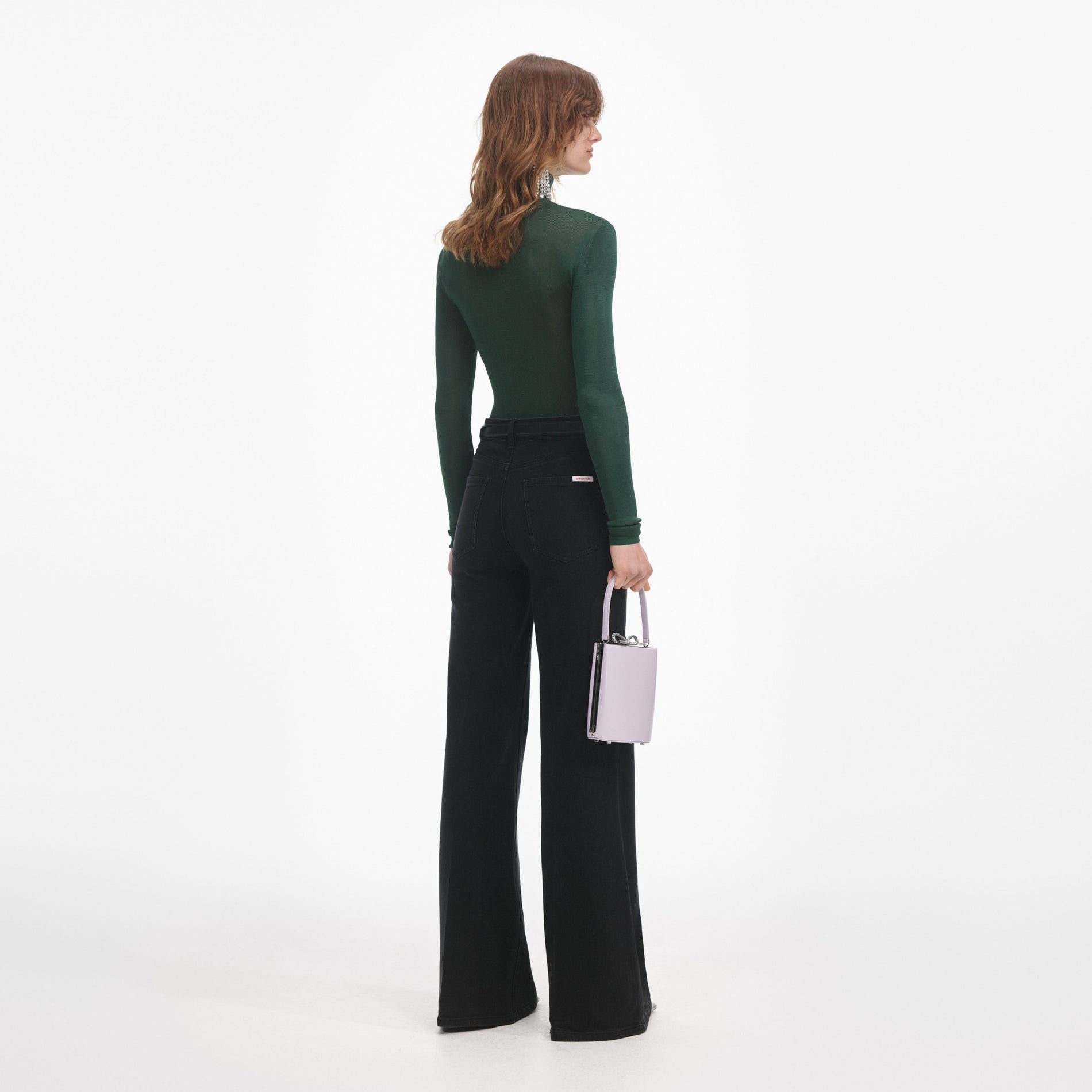 Back view of a woman wearing the Black Flared Jeans