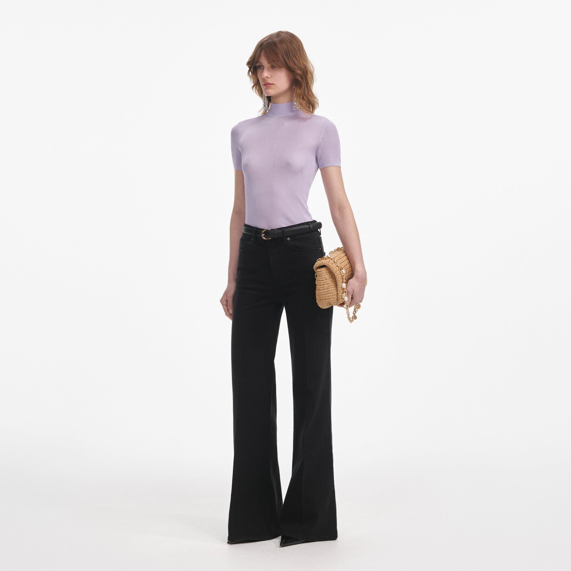 Side view of a woman wearing the Lilac Viscose Knit Short Sleeve Top