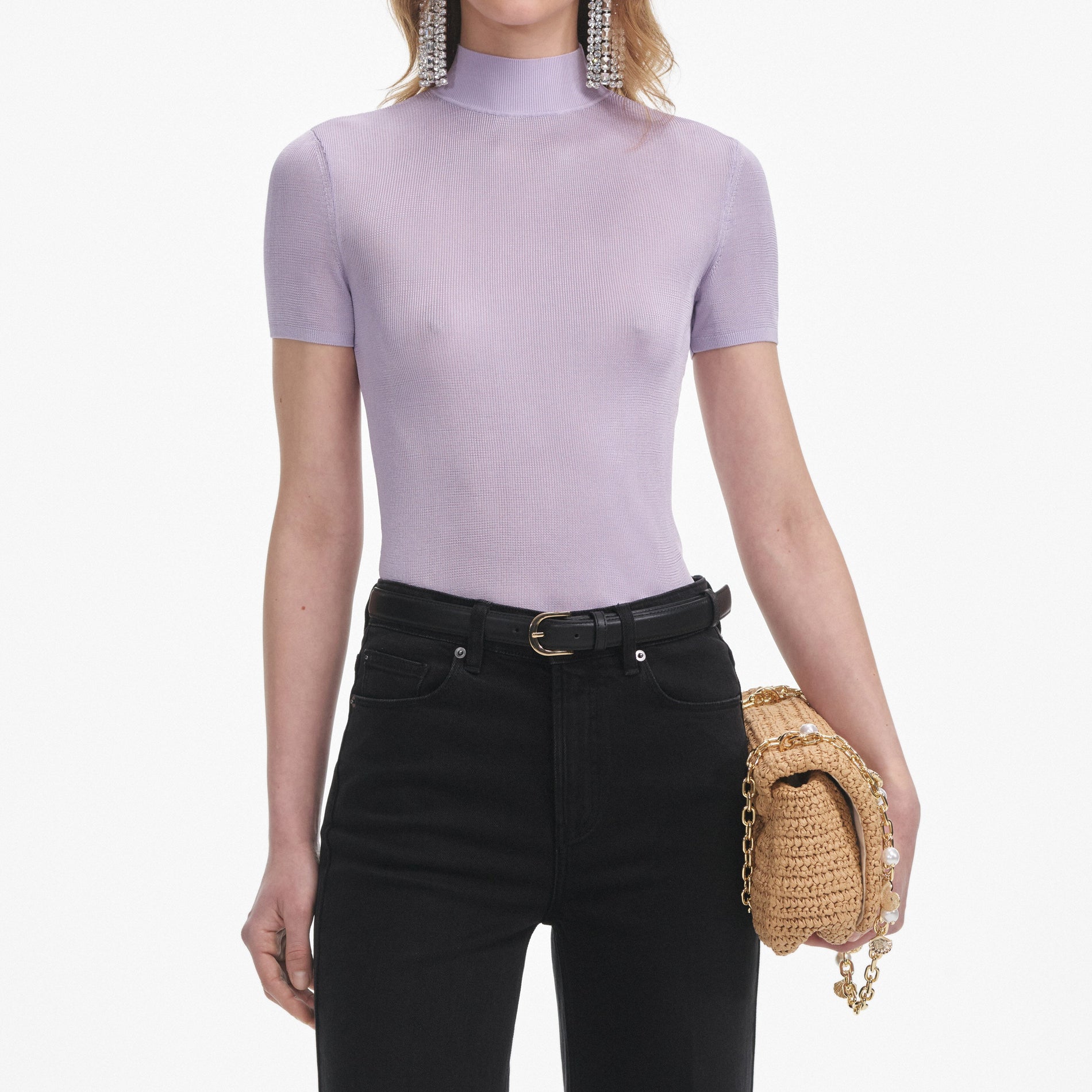 A close up of a woman wearing the Lilac Viscose Knit Short Sleeve Top