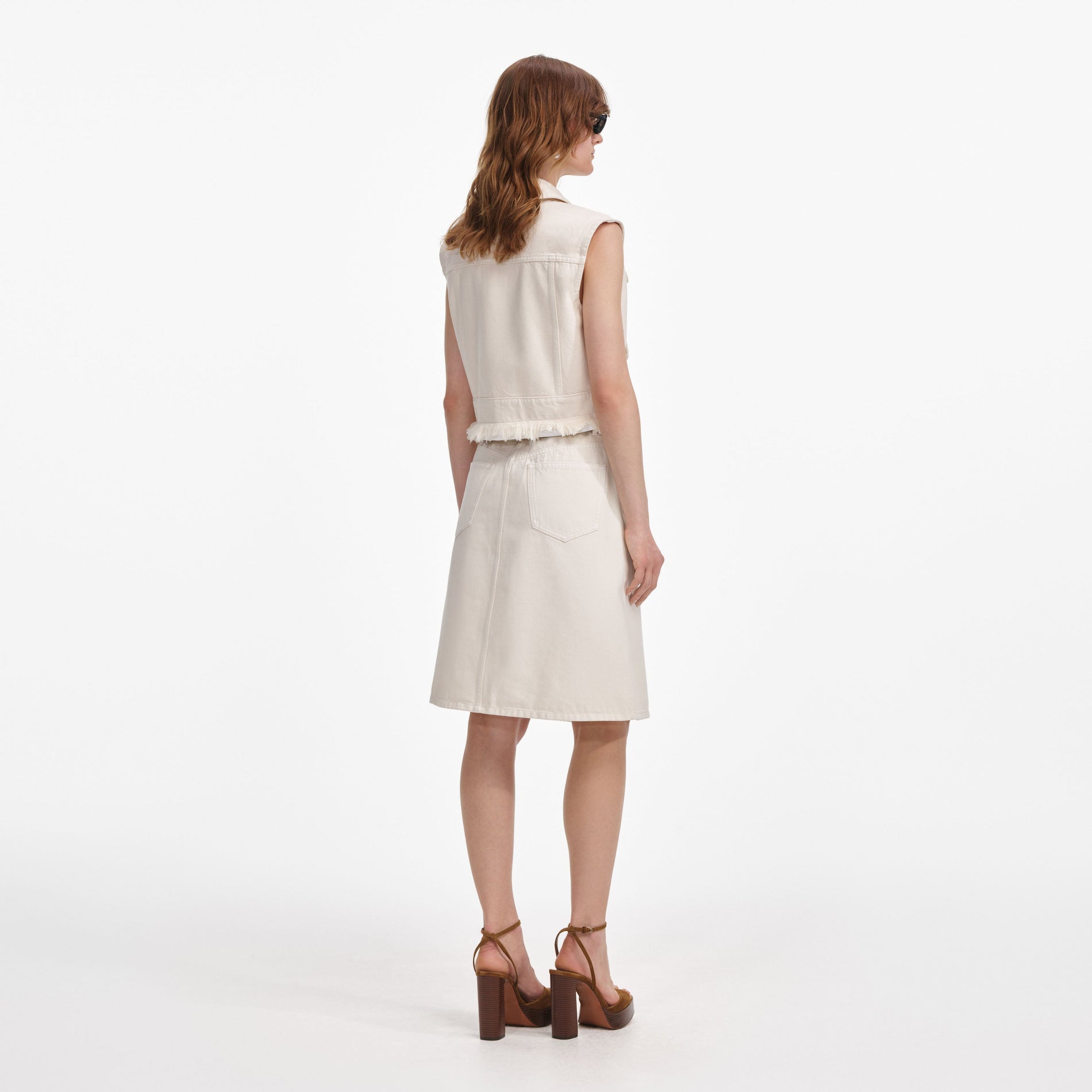 Back view of a woman wearing the Cream Denim Sleeveless Top
