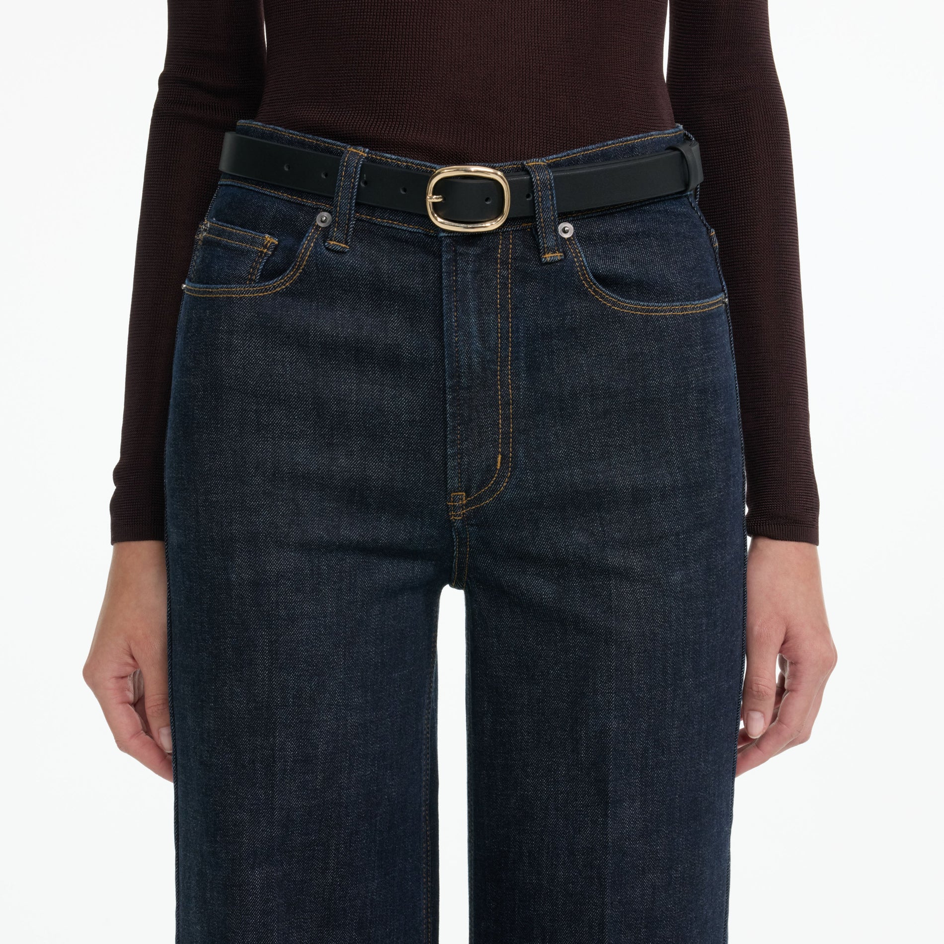 Side view of a woman wearing the Indigo Flared Jeans