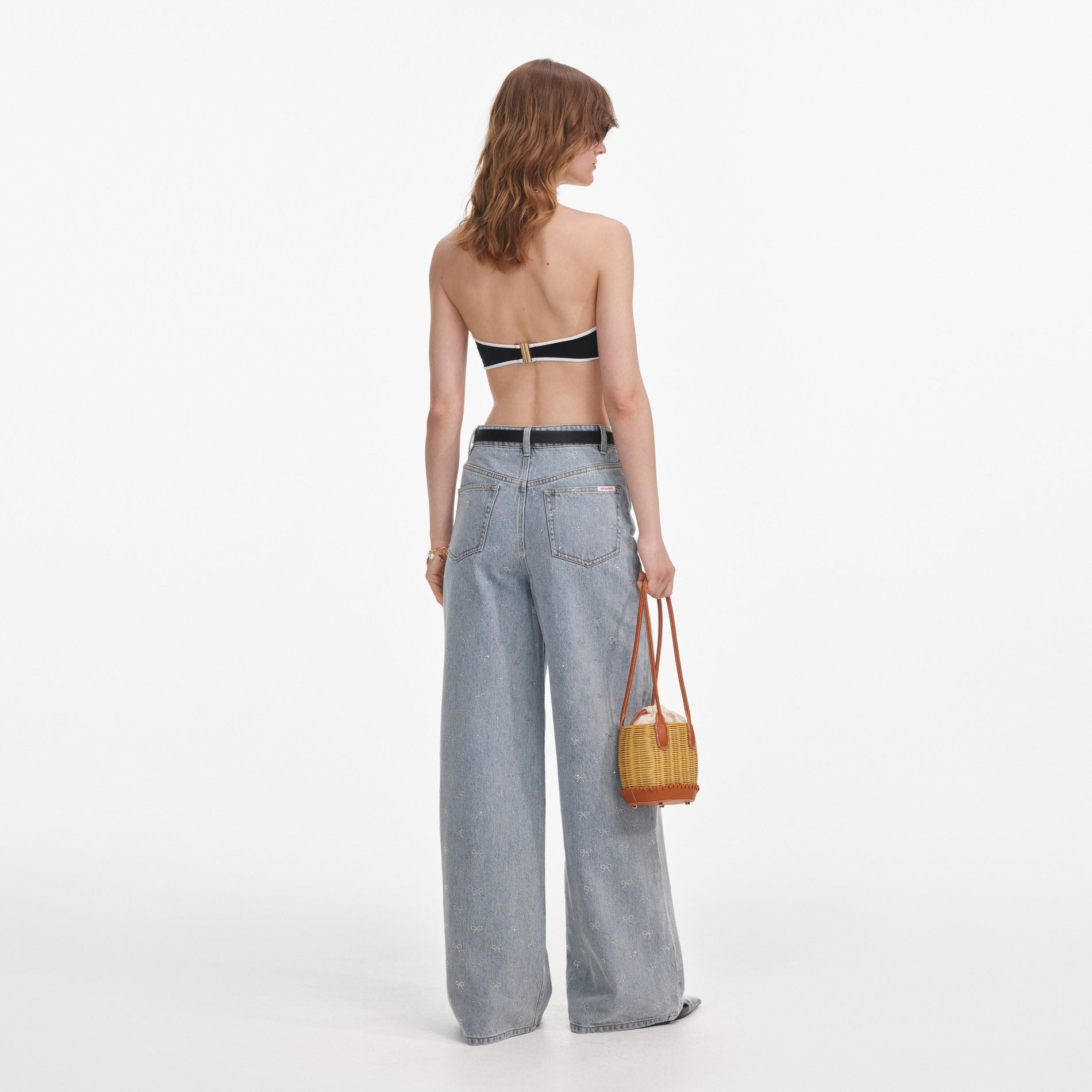 Back view of a woman wearing the Light Blue Diamante Bow Jeans