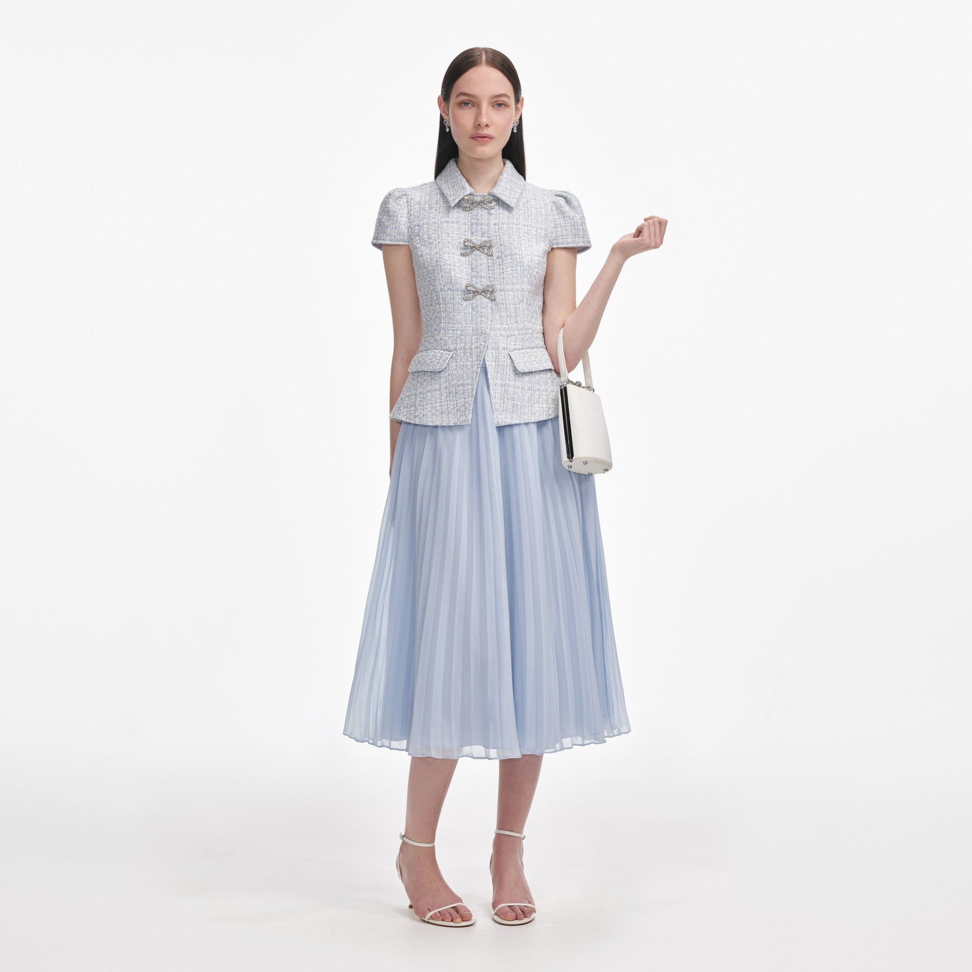 Front view of a woman wearing the Blue Boucle Bow Midi Dress