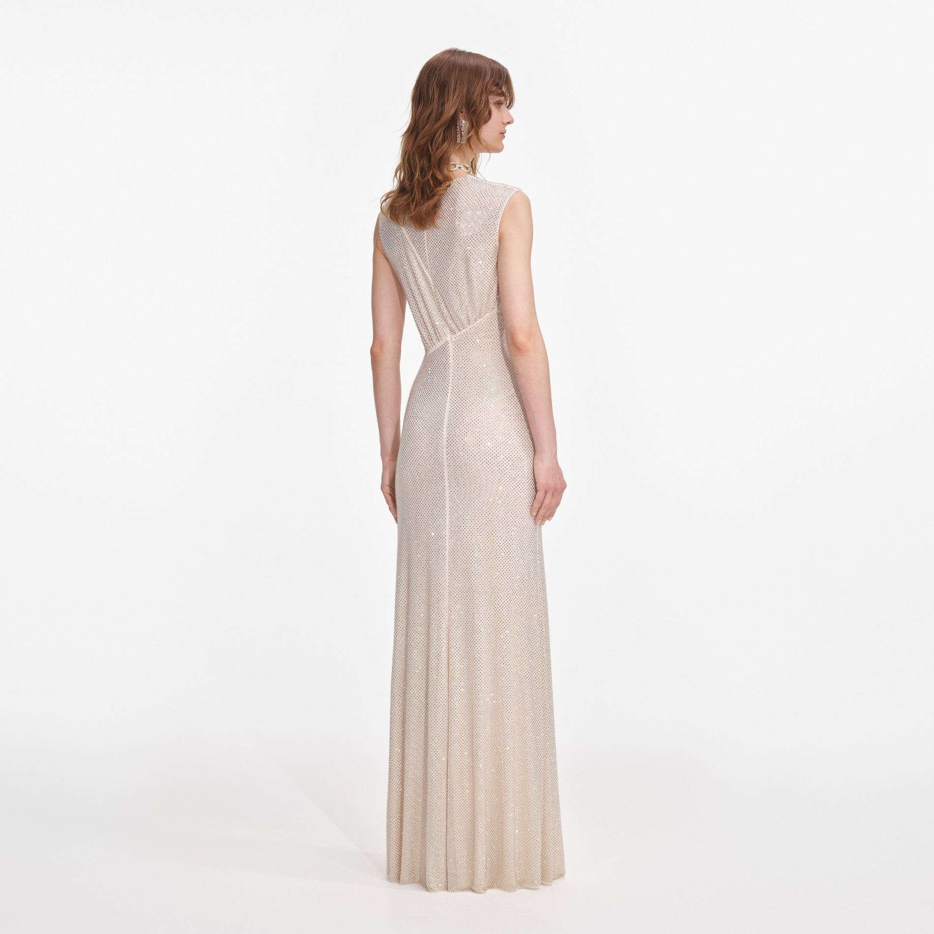 Back view of a woman wearing the Champagne Rhinestone Cut Out Maxi Dress