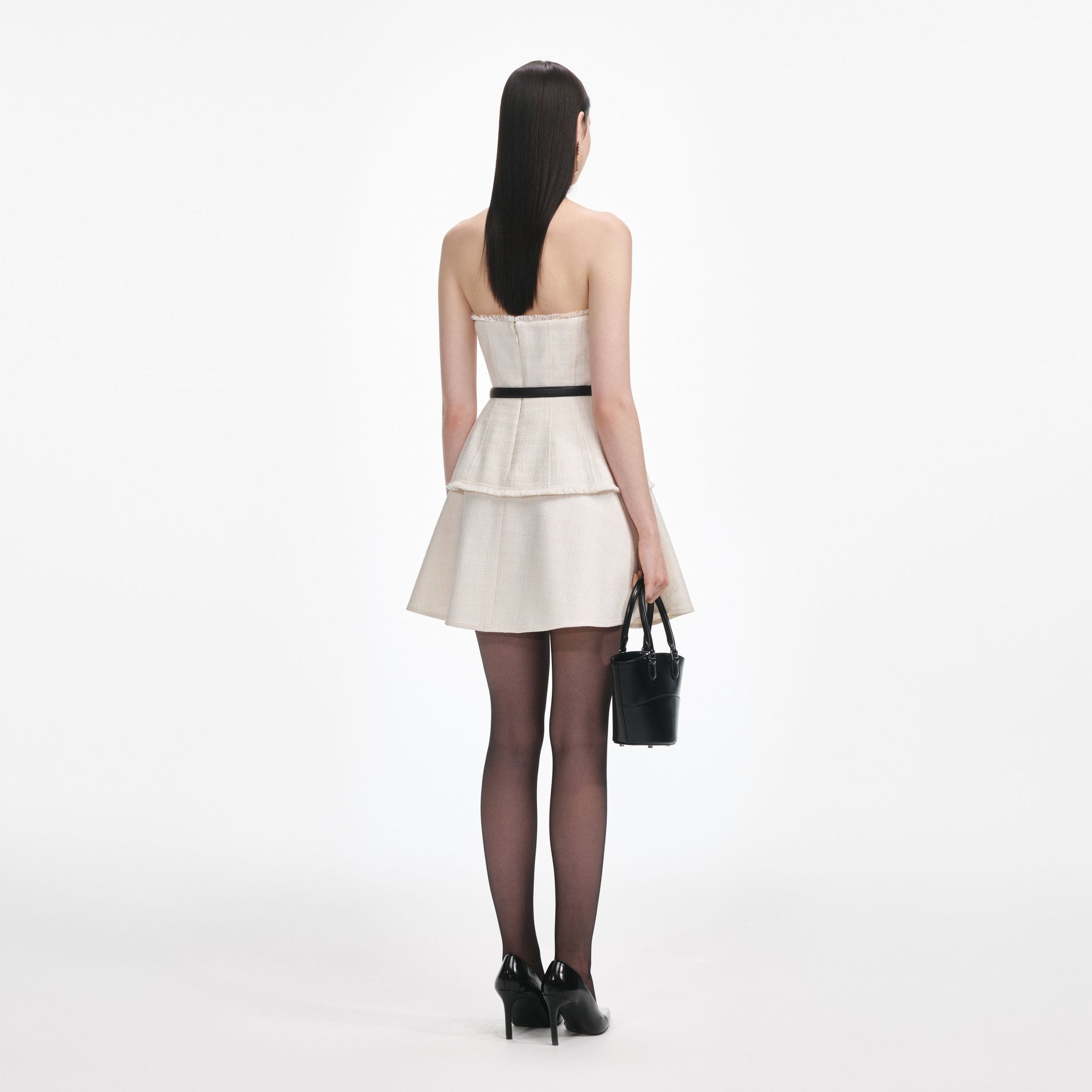 Back view of a woman wearing the Cream Boucle Bandeau Mini Dress