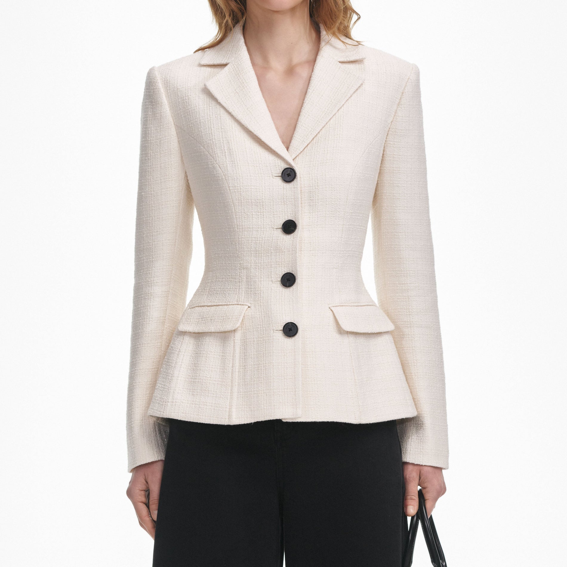 A close up of a woman wearing the Cream Boucle Jacket