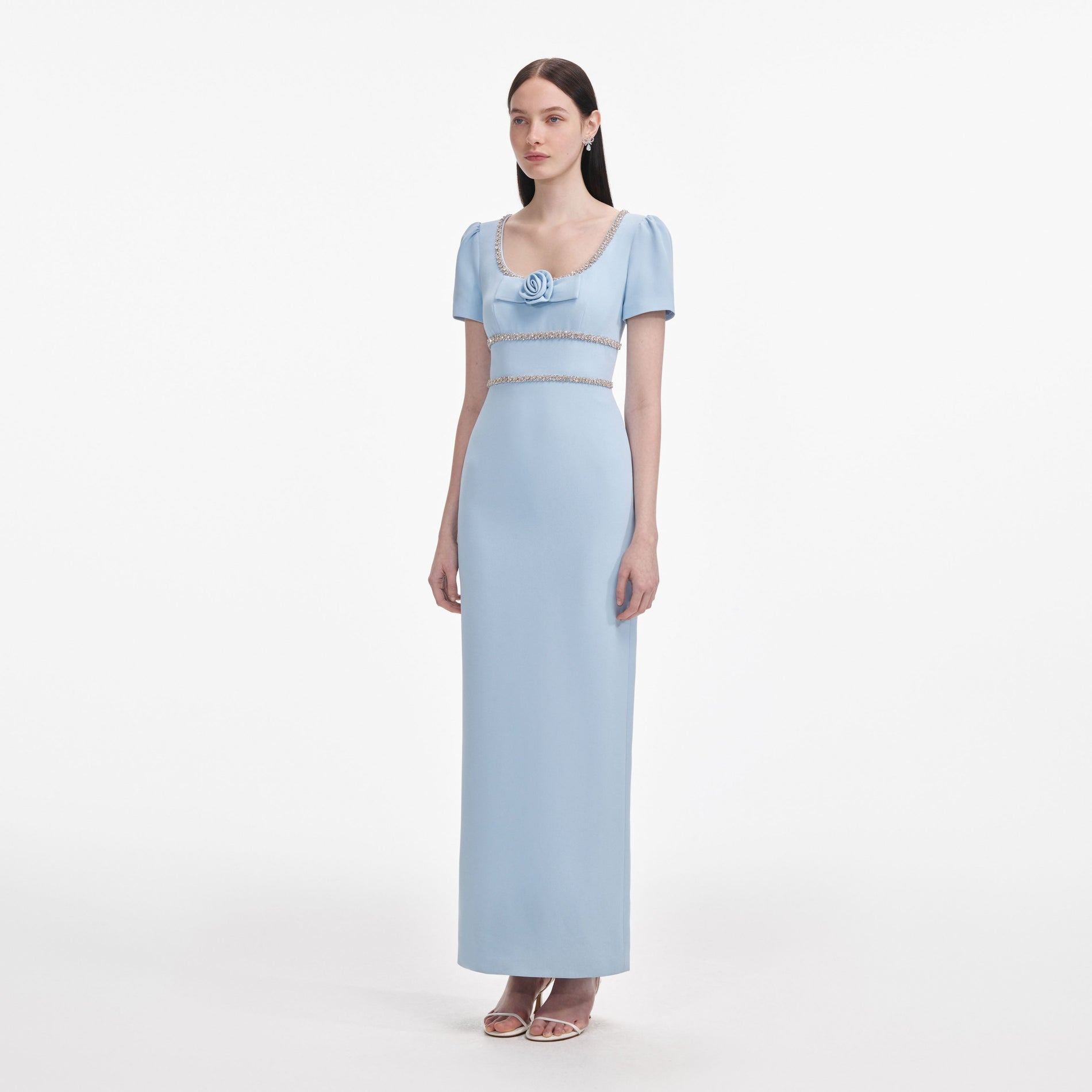 Side view of a woman wearing the Blue Crepe Crystal Trim Maxi Dress