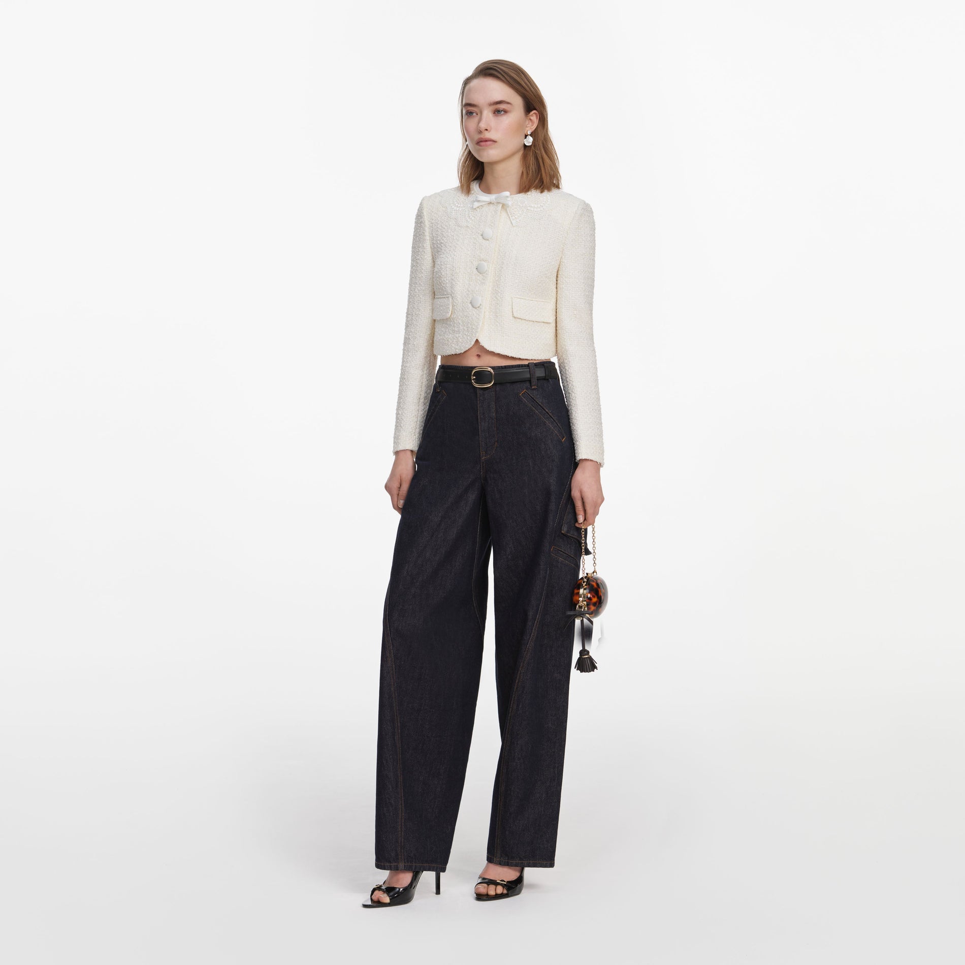 Side view of a woman wearing the Cream Boucle Lace Collar Jacket