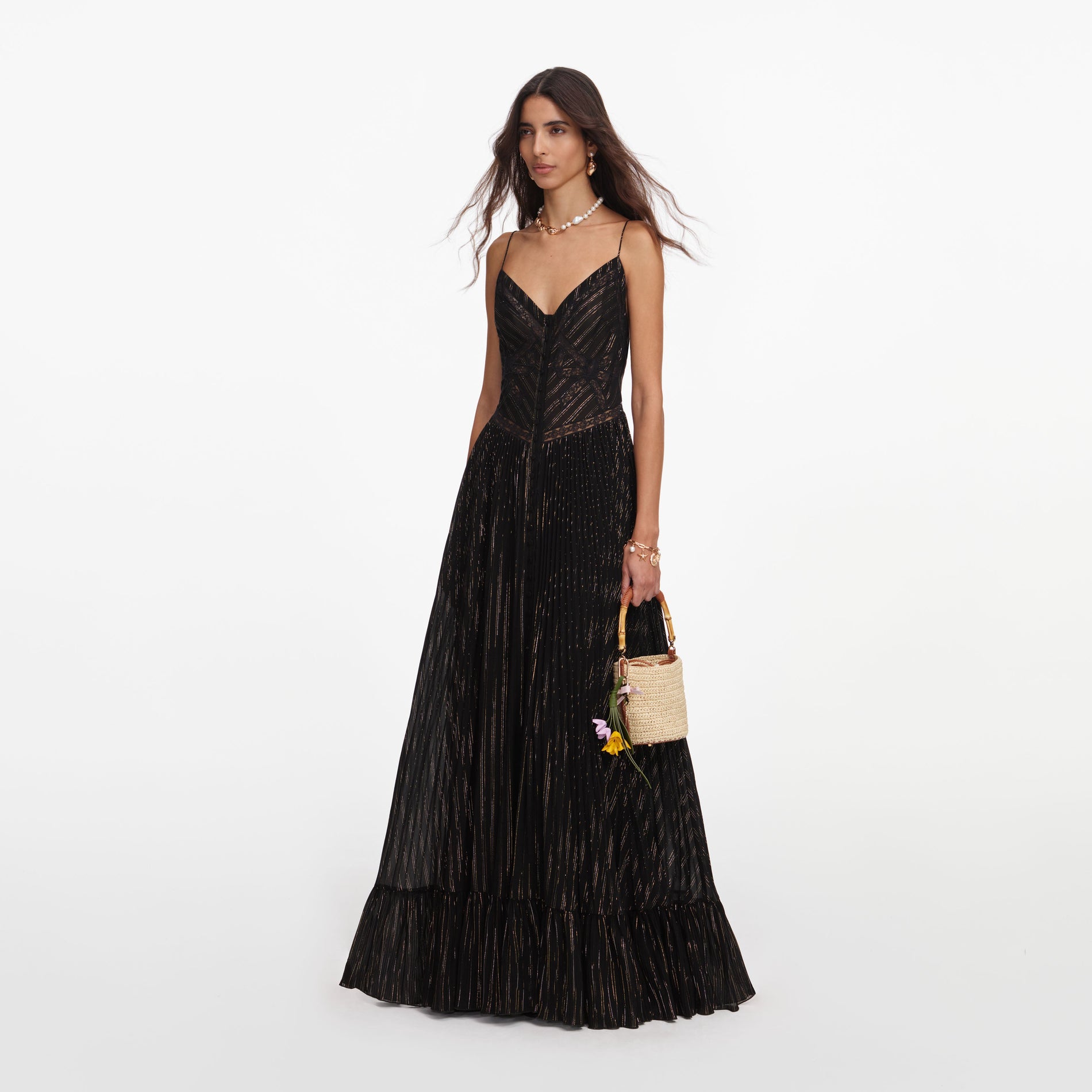 Side view of a woman wearing the Black Lurex Stripe Pleated Maxi Dress