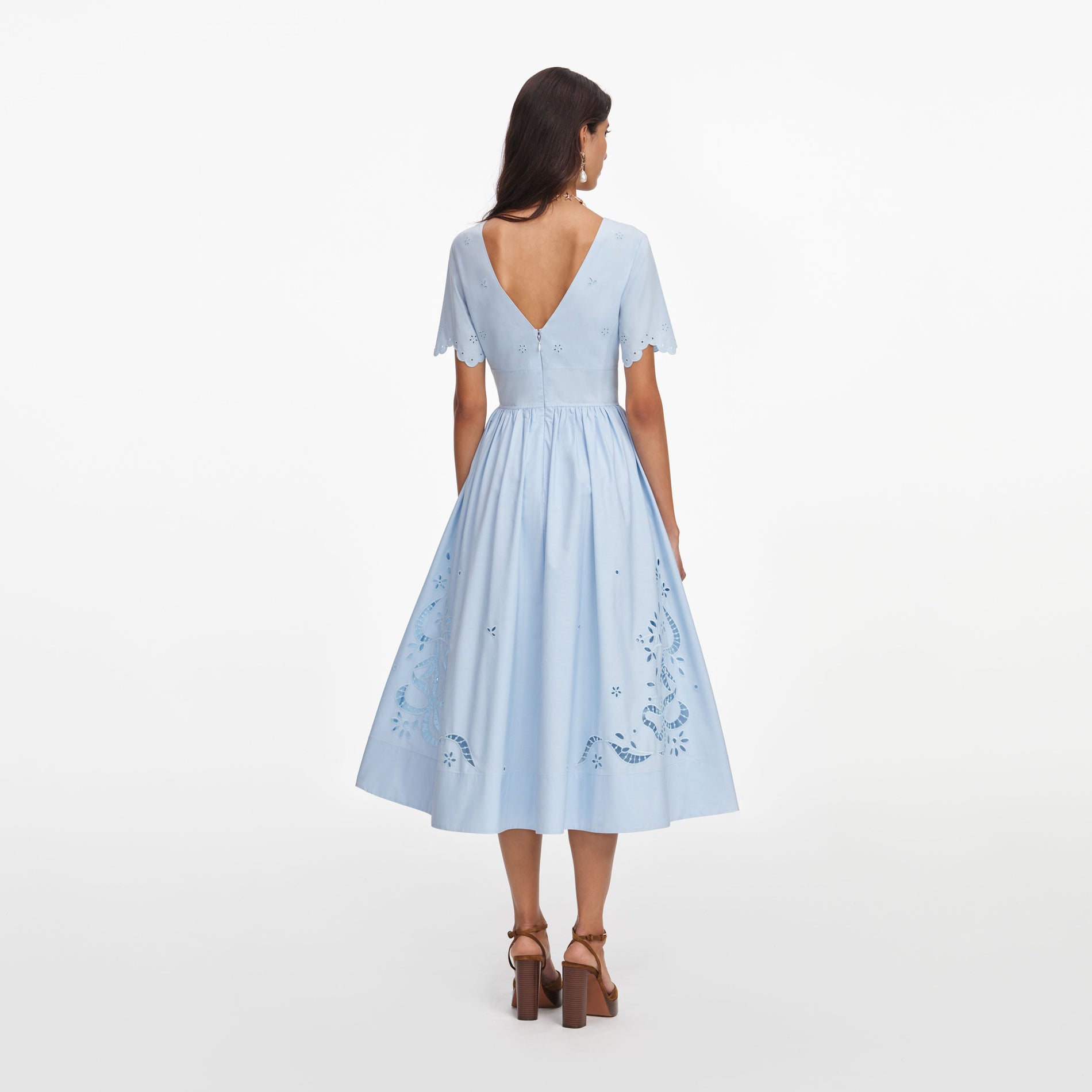 Back view of a woman wearing the Blue Cotton Embroidered Midi Dress