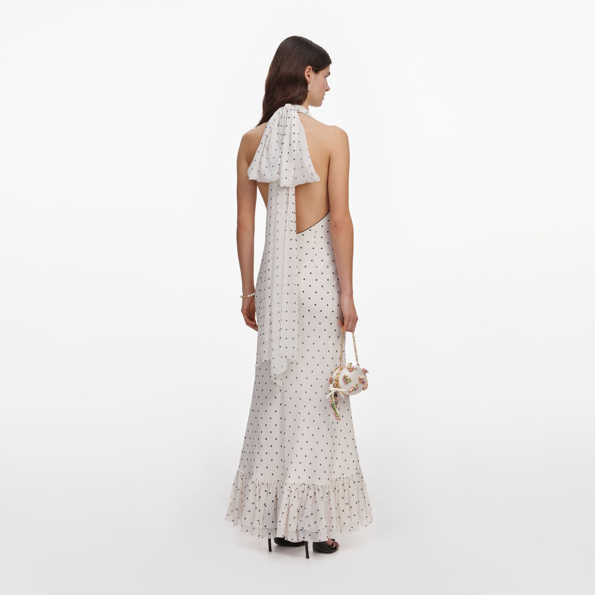 Back view of a woman wearing the Polka Dot Halter Neck Midi Dress
