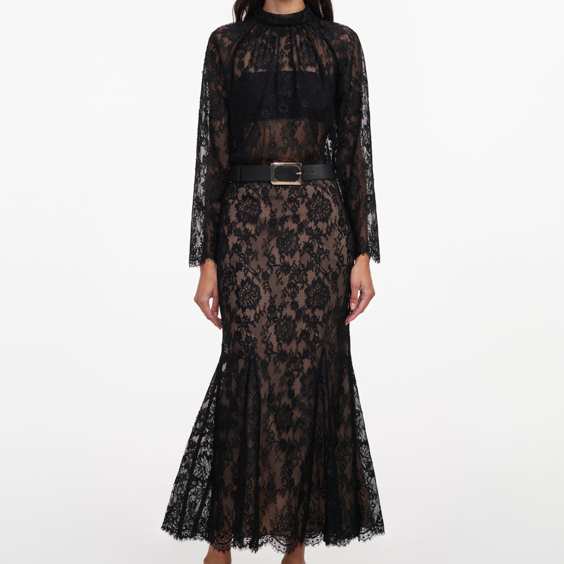 A close up of a woman wearing the Black Lace Midi Skirt