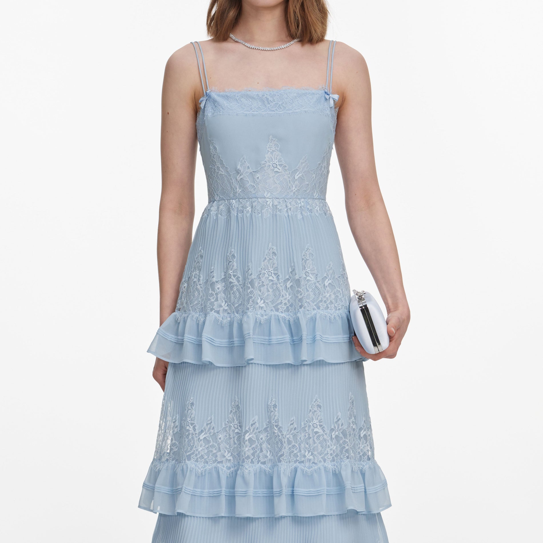 A close up of a woman wearing the Blue Chiffon Lace Tiered Midi Dress