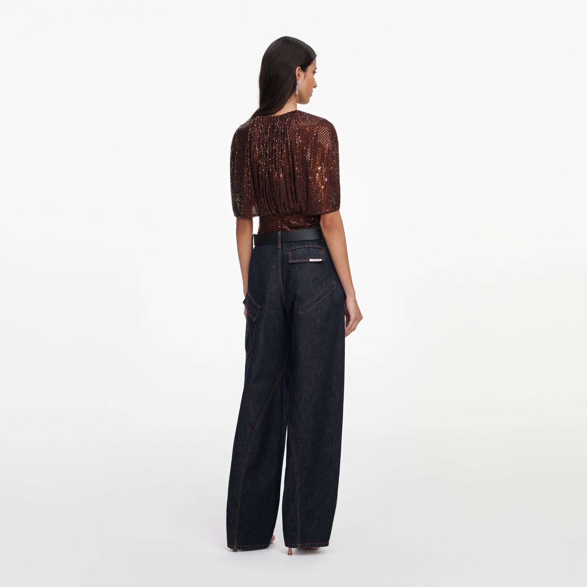 Back view of a woman wearing the Brown Rhinestone Cape Sleeve Top