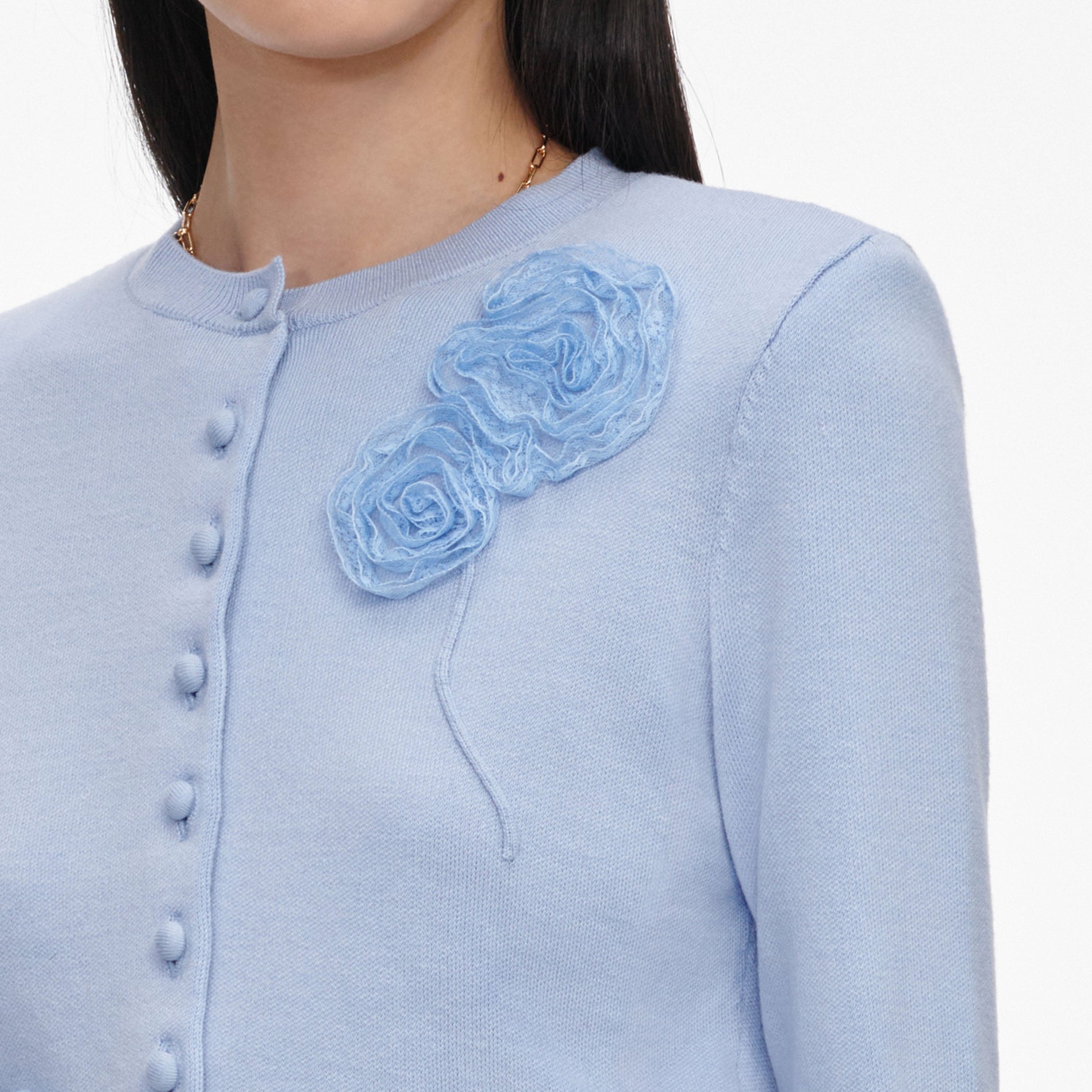 A close up of a woman wearing the Blue Flower Knit Cardigan