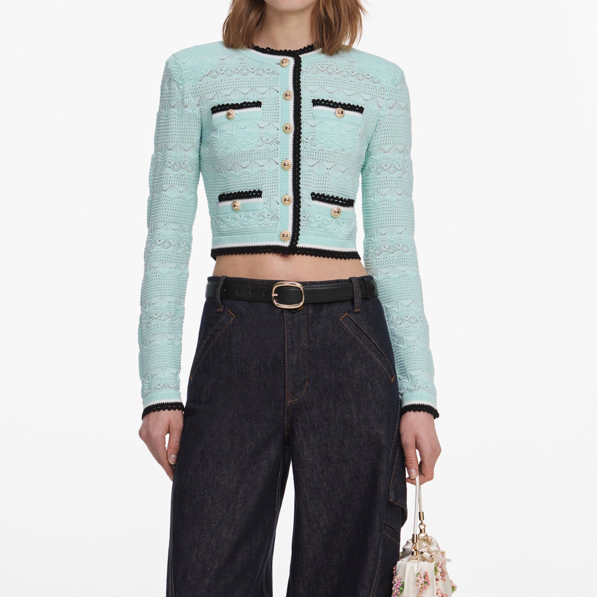 A close up of a woman wearing the Mint Pointelle Knit Cardigan