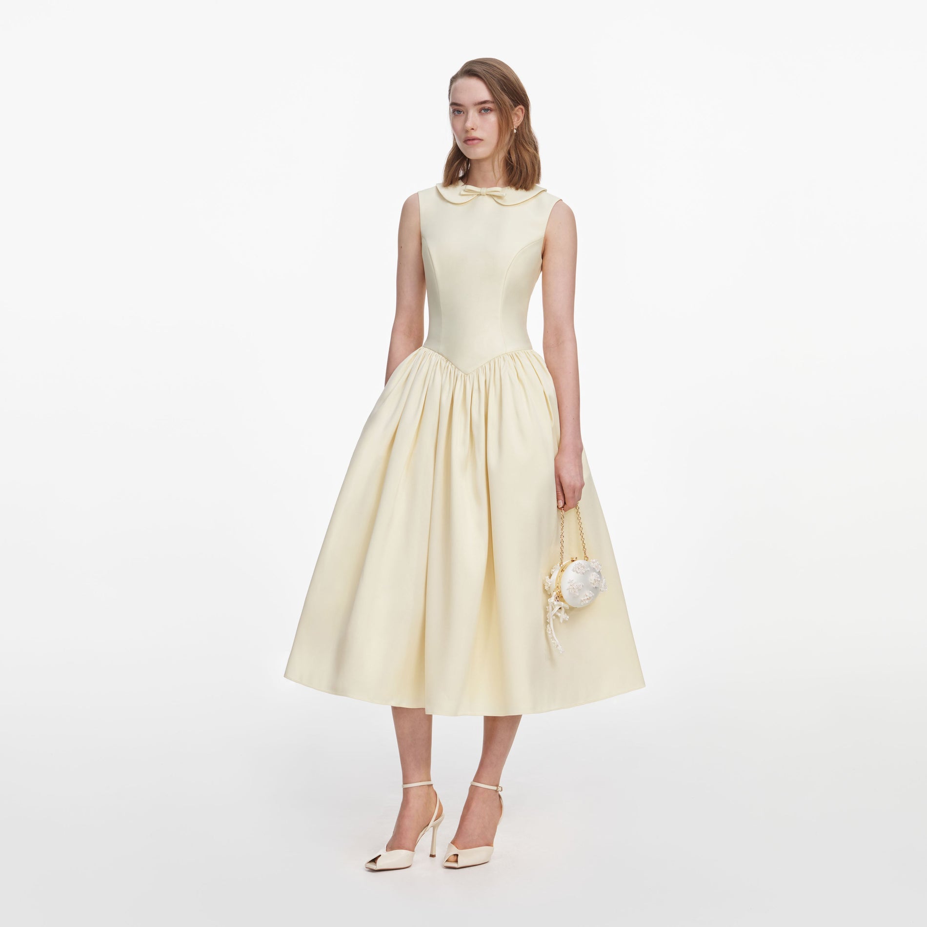Side view of a woman wearing the Yellow Taffeta Collared Midi Dress