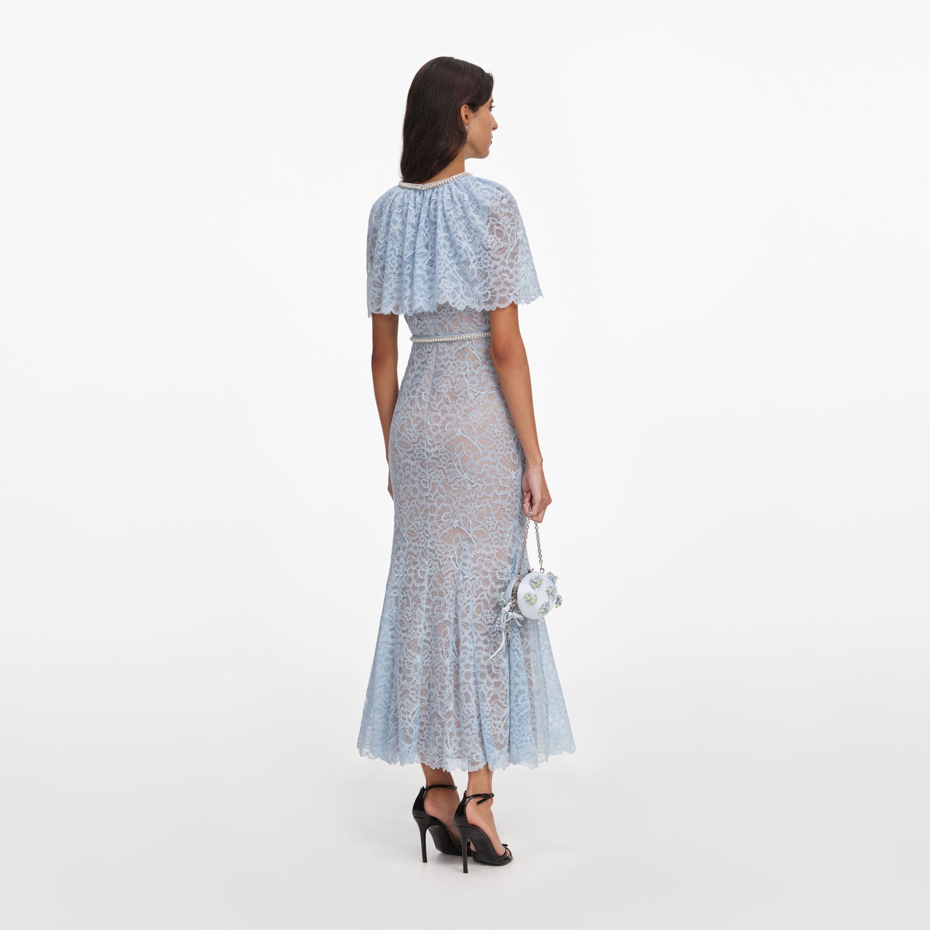 Back view of a woman wearing the Blue Lace Cape Midi Dress