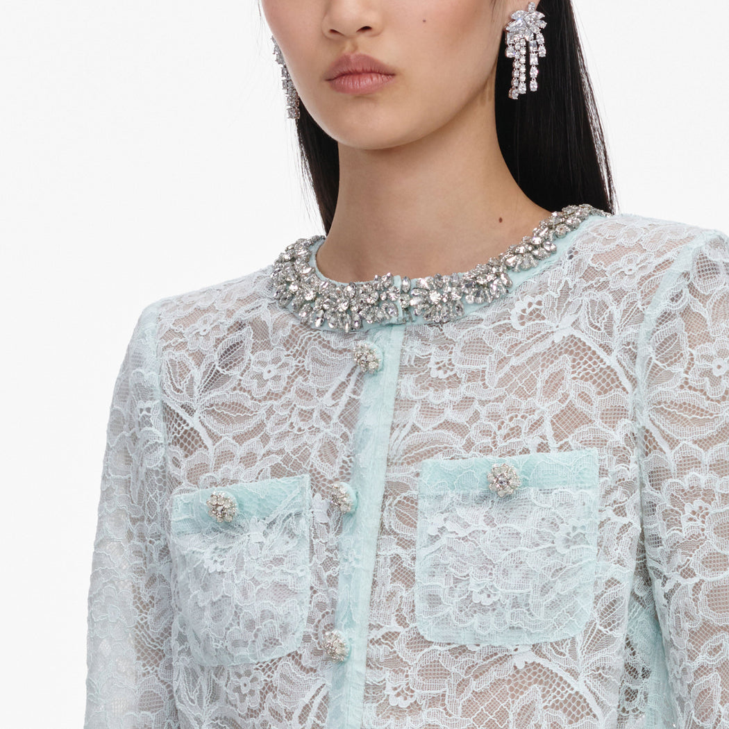 A close up of a woman wearing the Mint Lace Crystal Embellished Jacket