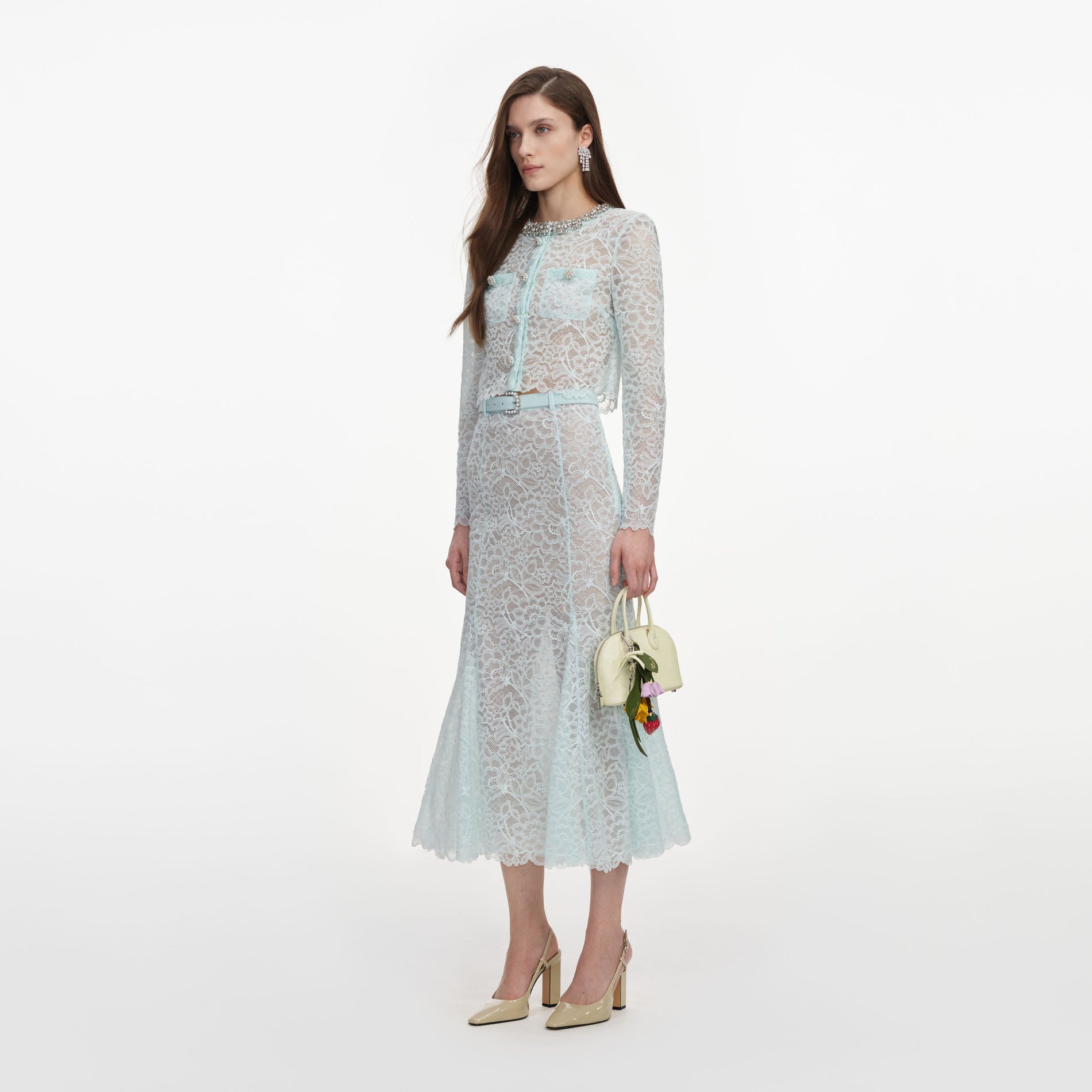 Side view of a woman wearing the Mint Lace Midi Skirt