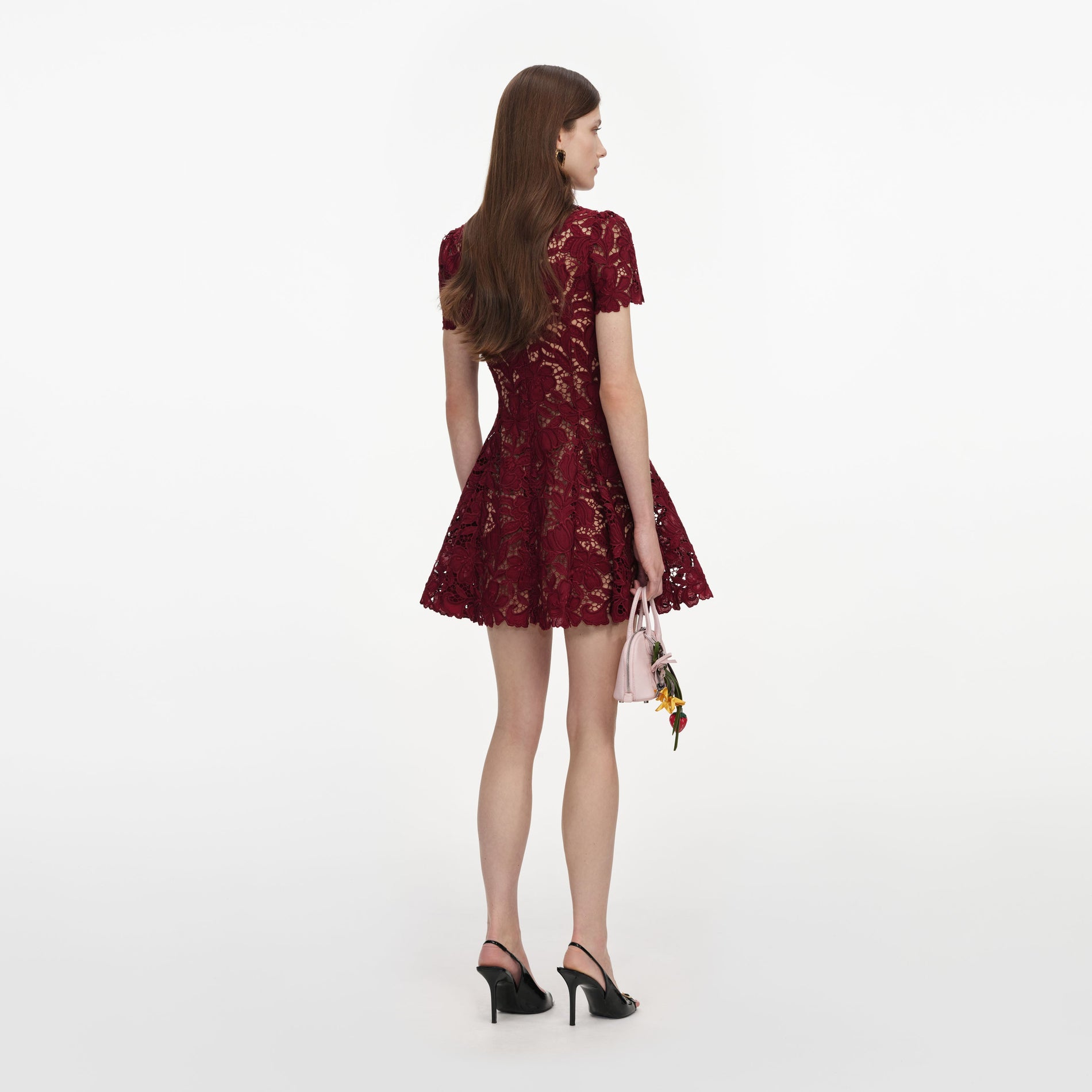 Back view of a woman wearing the Burgundy Lace Mini Dress