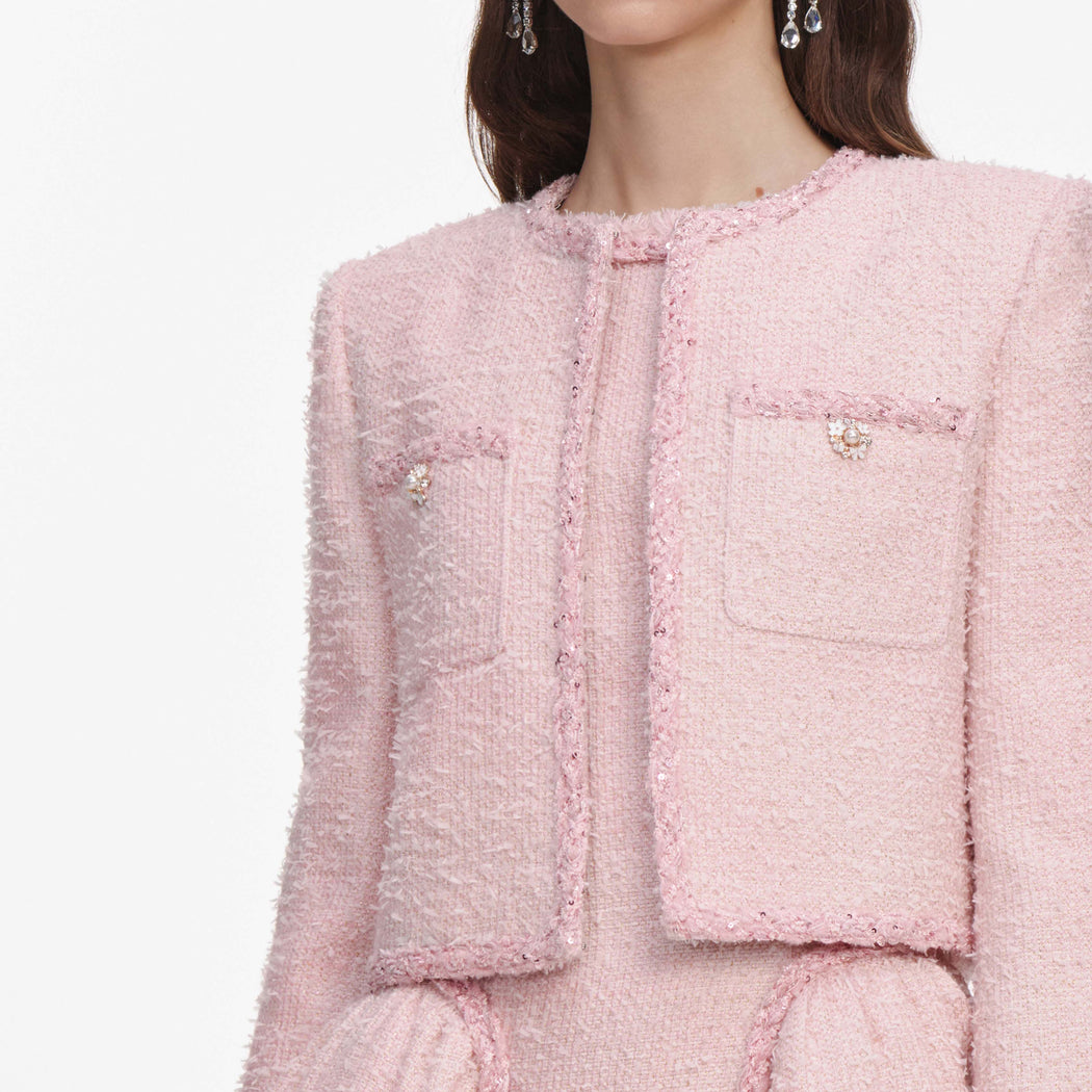 A close up of a woman wearing the Pink Boucle Jacket