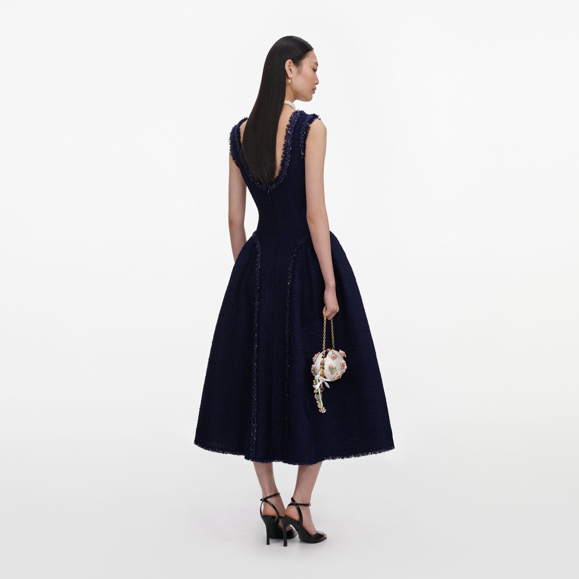 Back view of a woman wearing the Navy Boucle Midi Dress