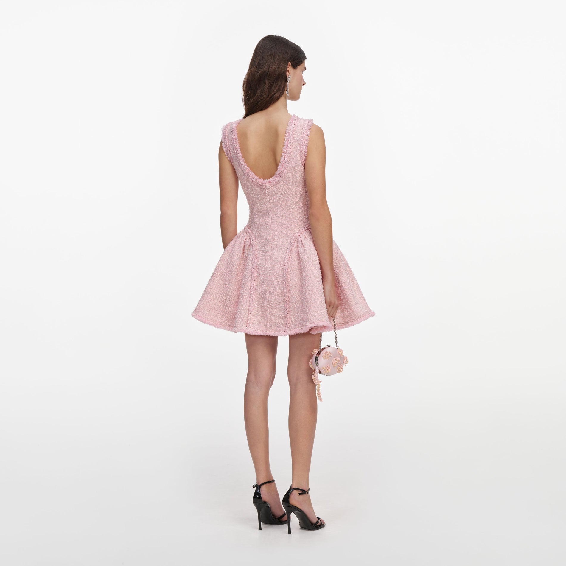 Back view of a woman wearing the Pink Boucle Sleeveless Mini Dress