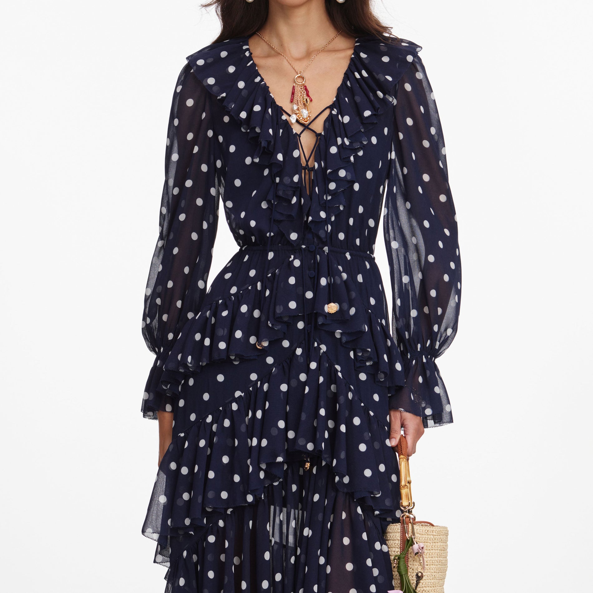 A close up of a woman wearing the Polka Dot Georgette Ruffle Maxi Dress