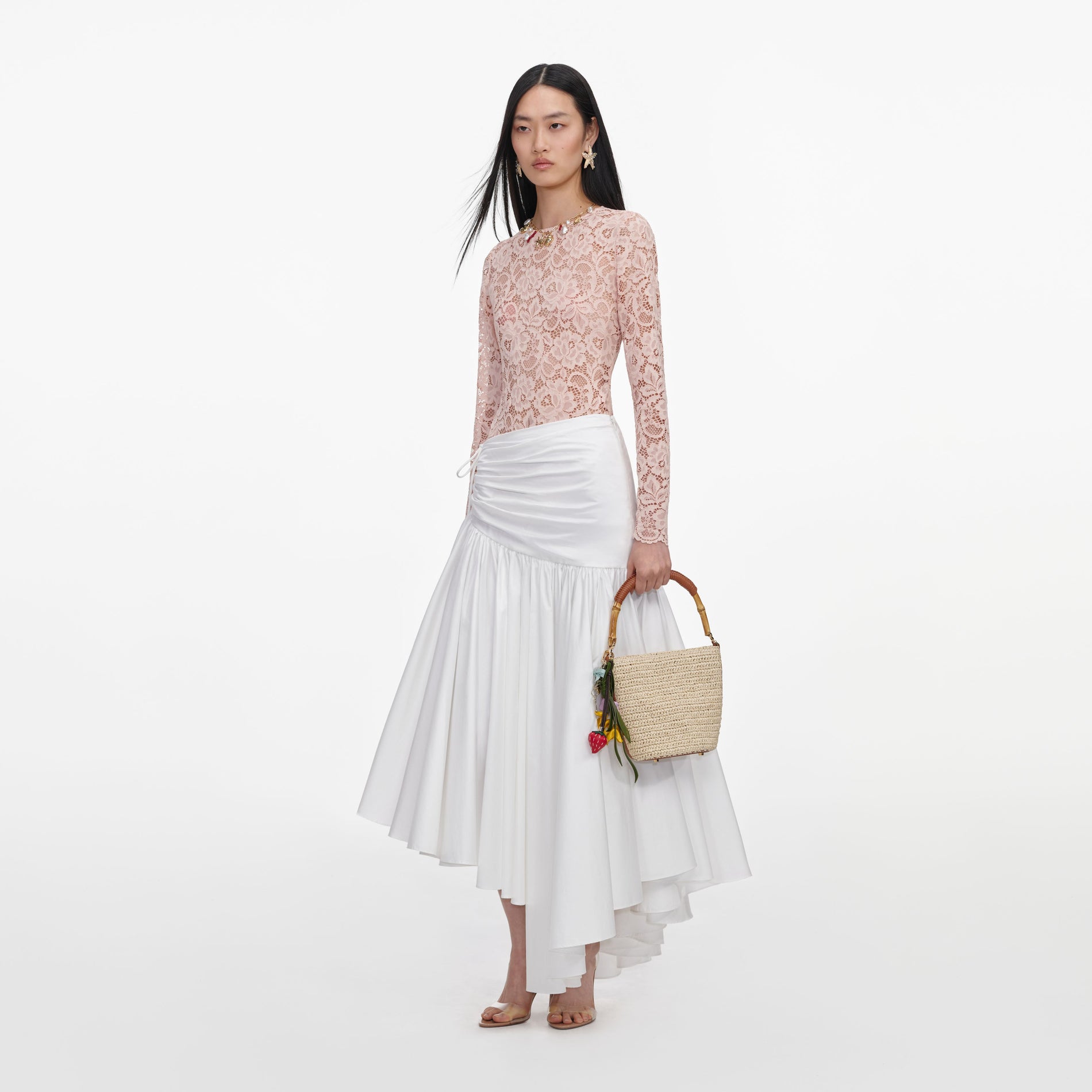 Side view of a woman wearing the White Cotton Asymmetric Midi Skirt