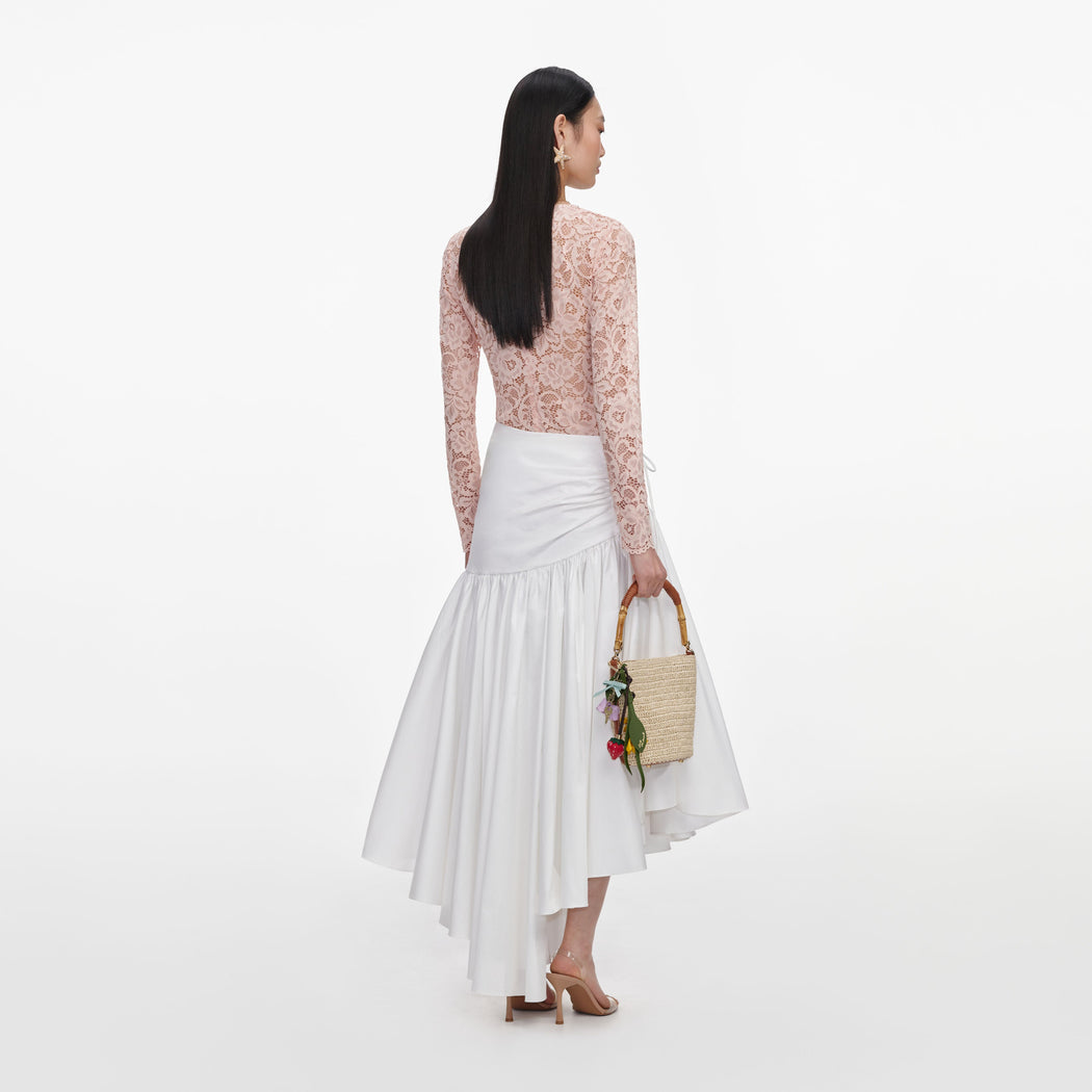 Back view of a woman wearing the Beige Floral Lace Bodysuit
