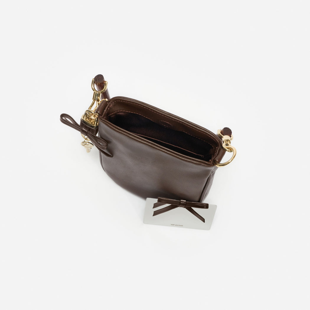 Brown leather shoulder bag with gold hardware and an open top, revealing a dark brown interior
