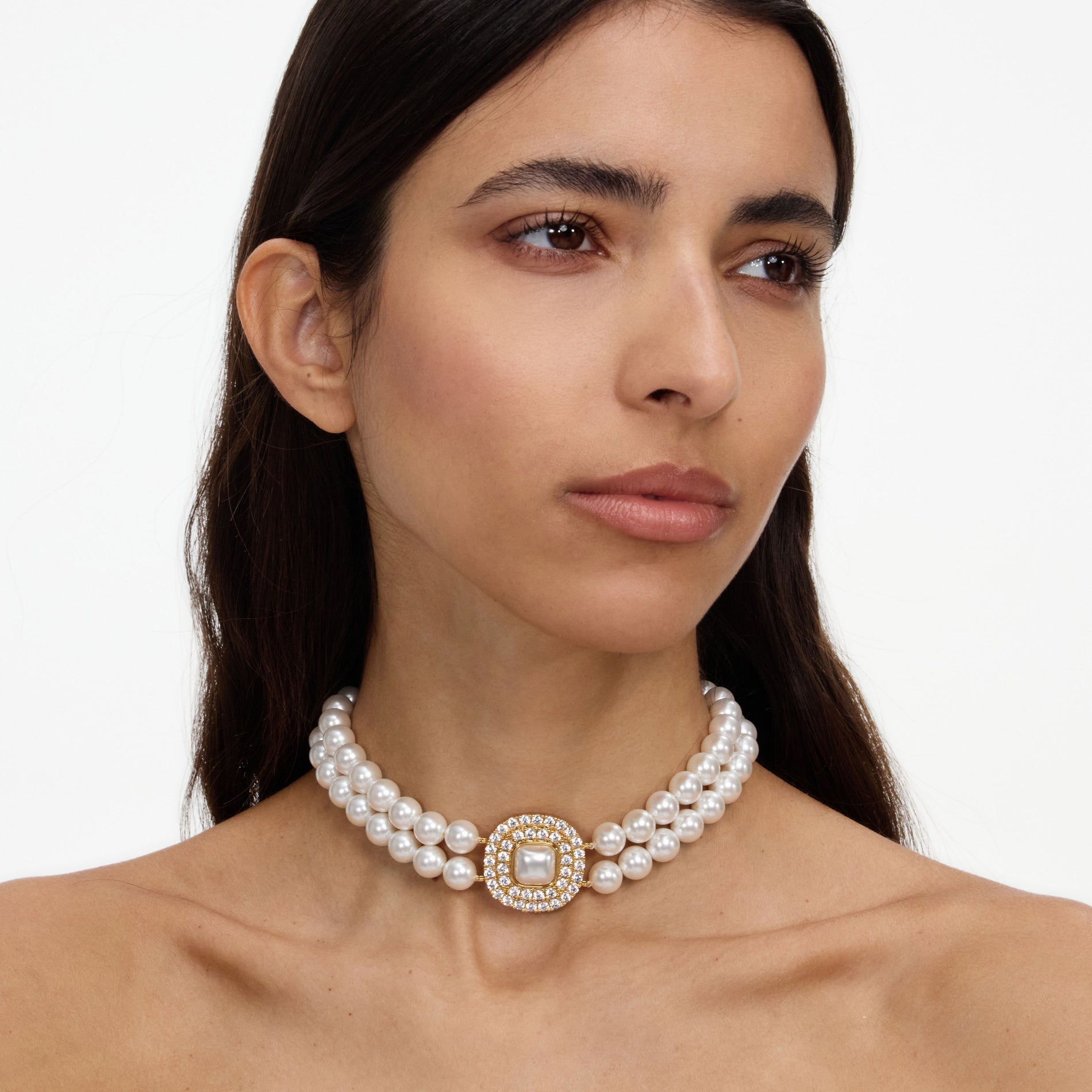 A close up of a woman wearing the Gold Crystal Pearl Choker