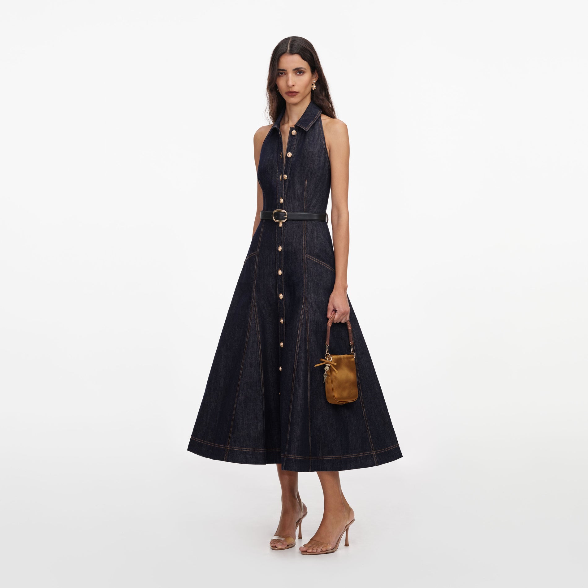 Side view of a woman wearing the Indigo Denim Halterneck Midi Dress