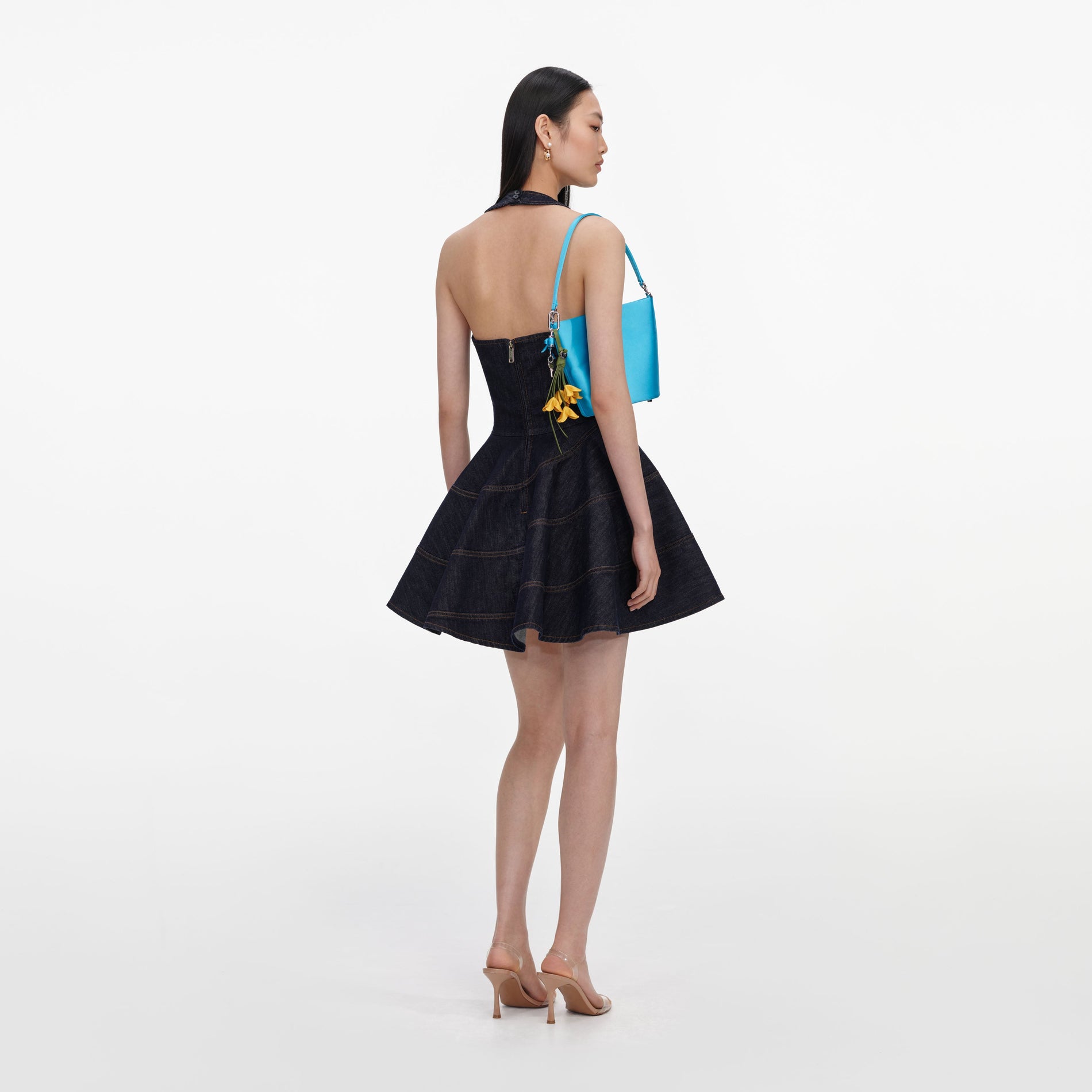 Back view of a woman wearing the Indigo Denim Halterneck Mini Dress