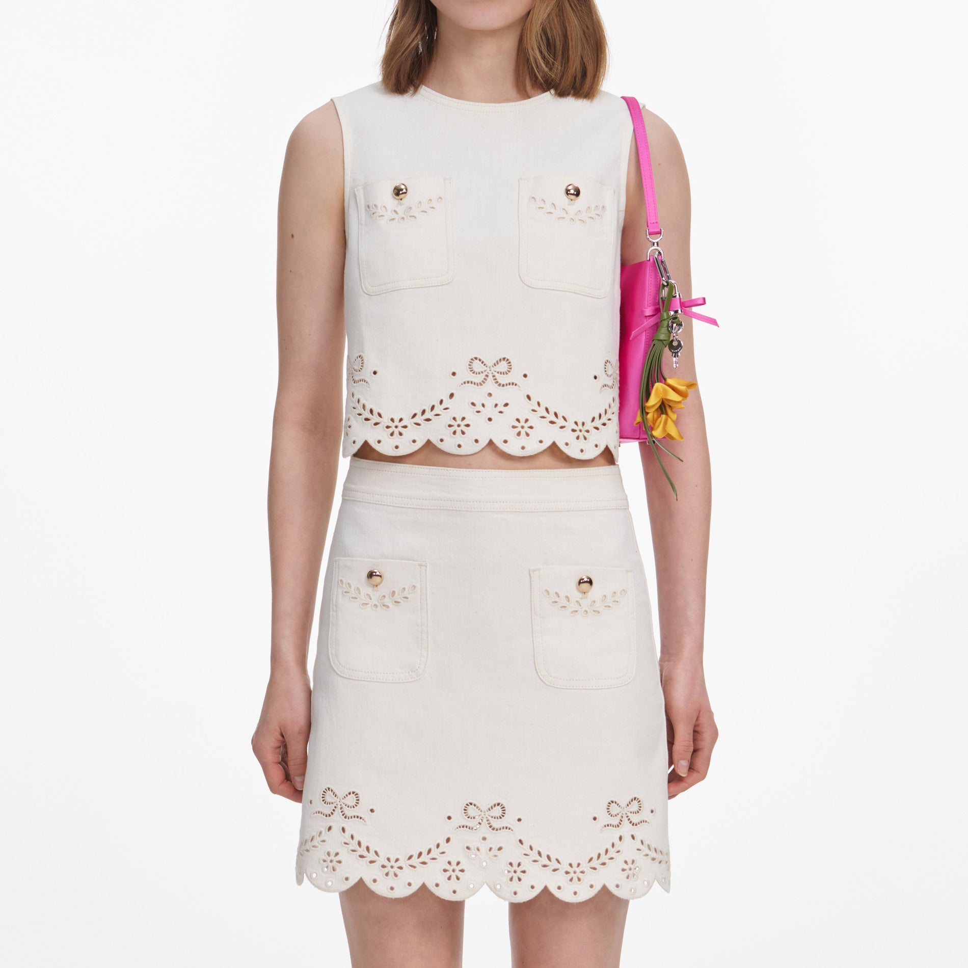 A close up of a woman wearing the Cream Broderie Denim Mini Skirt