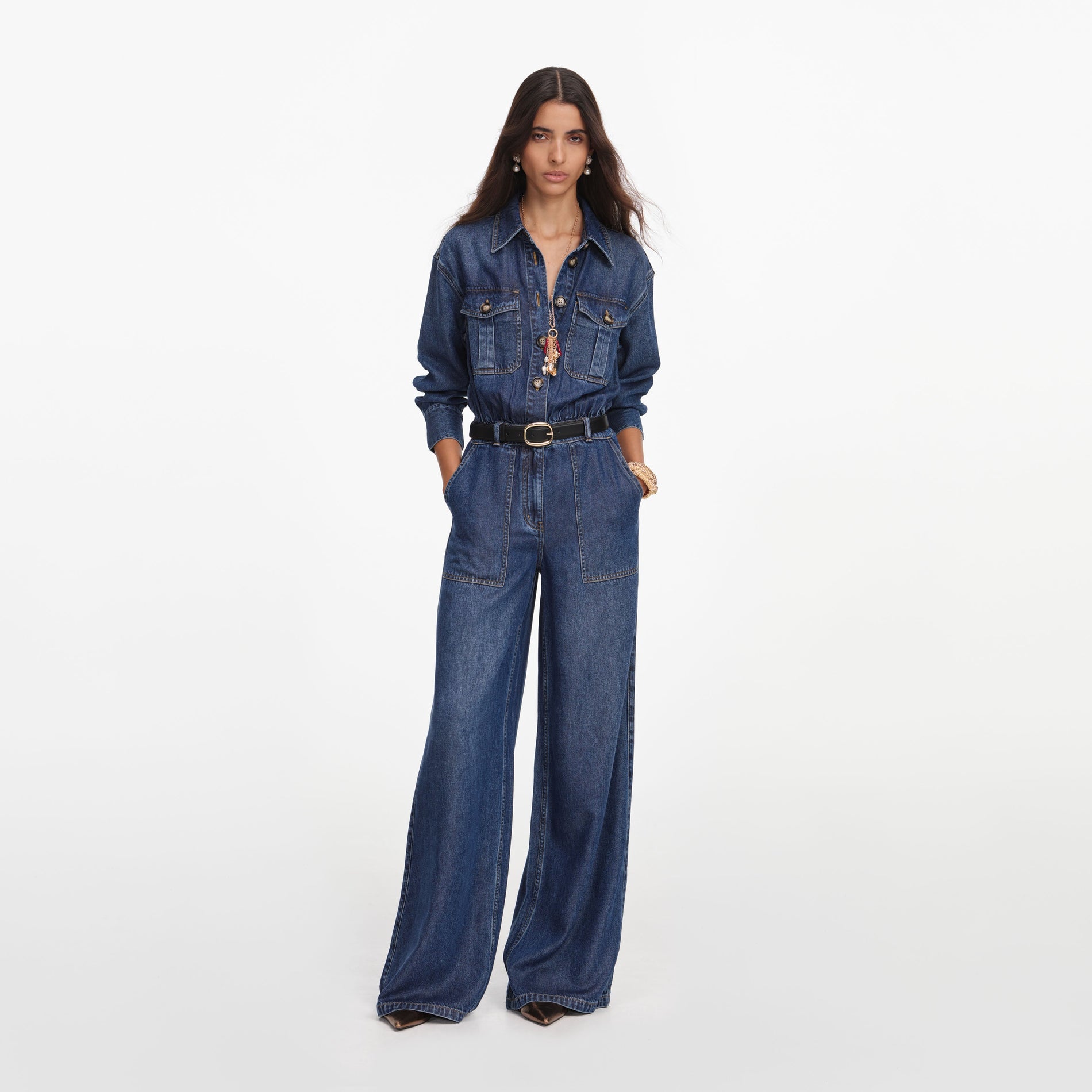 Front view of a woman wearing the Denim Relaxed Fit Jumpsuit