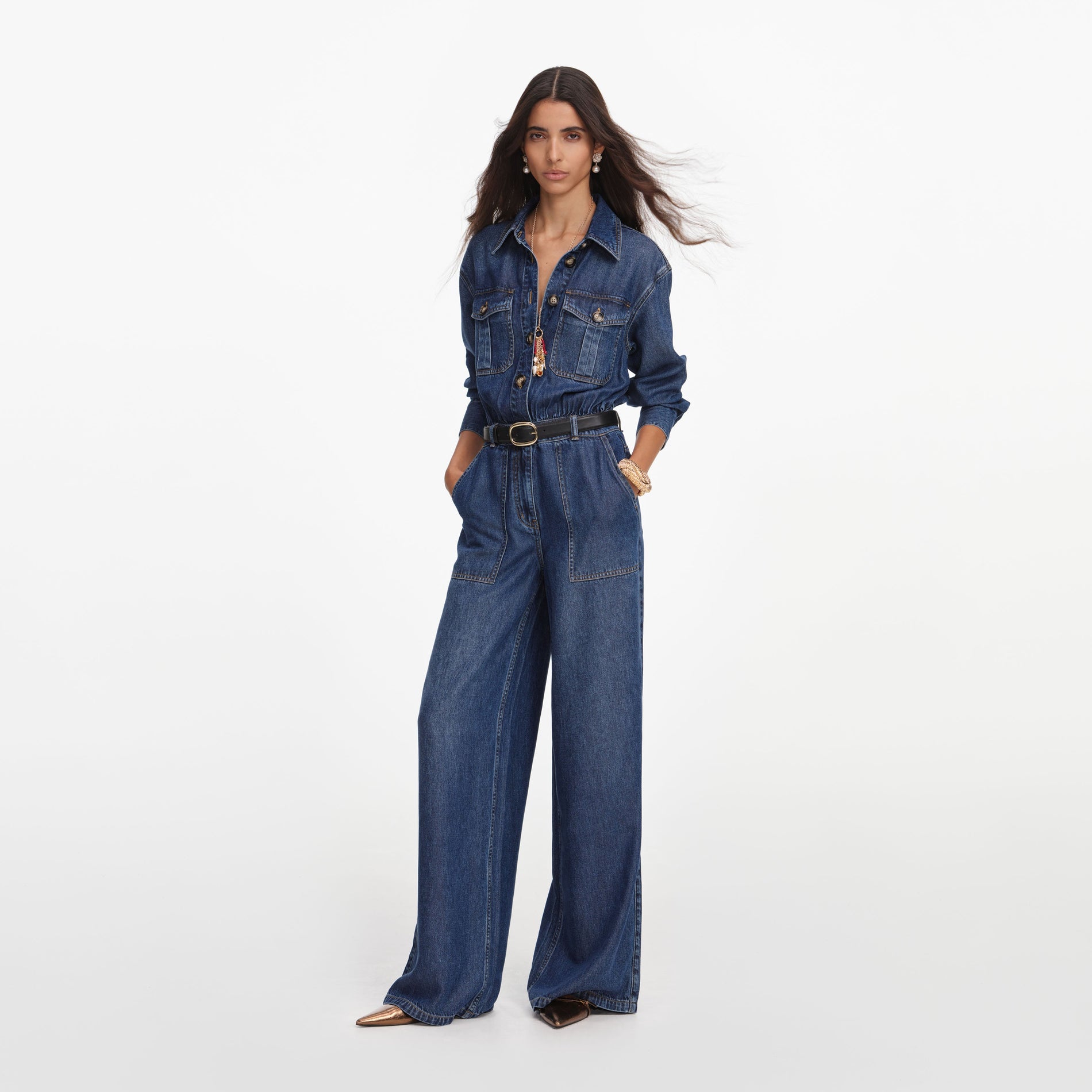 Side view of a woman wearing the Denim Relaxed Fit Jumpsuit