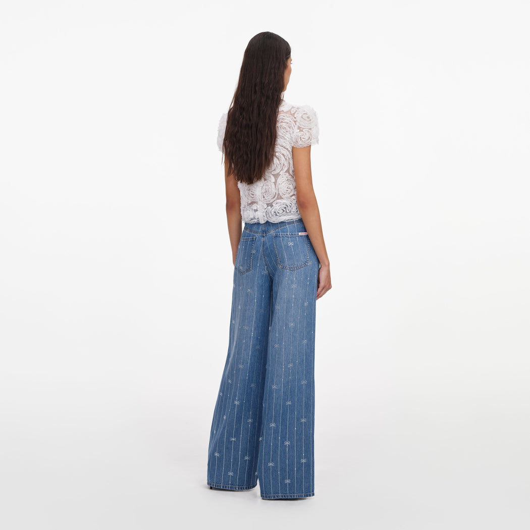 Back view of a woman wearing the Light Blue Rhinestone Stripe Denim Jeans