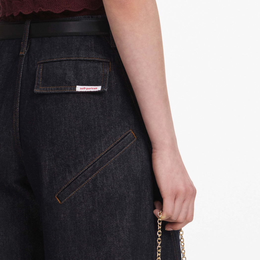 A close up of a woman wearing the Indigo Denim Cargo Jeans