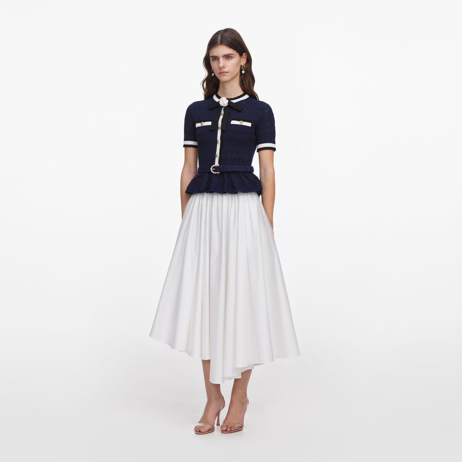 Side view of a woman wearing the Navy Peplum Pointelle Knit Top