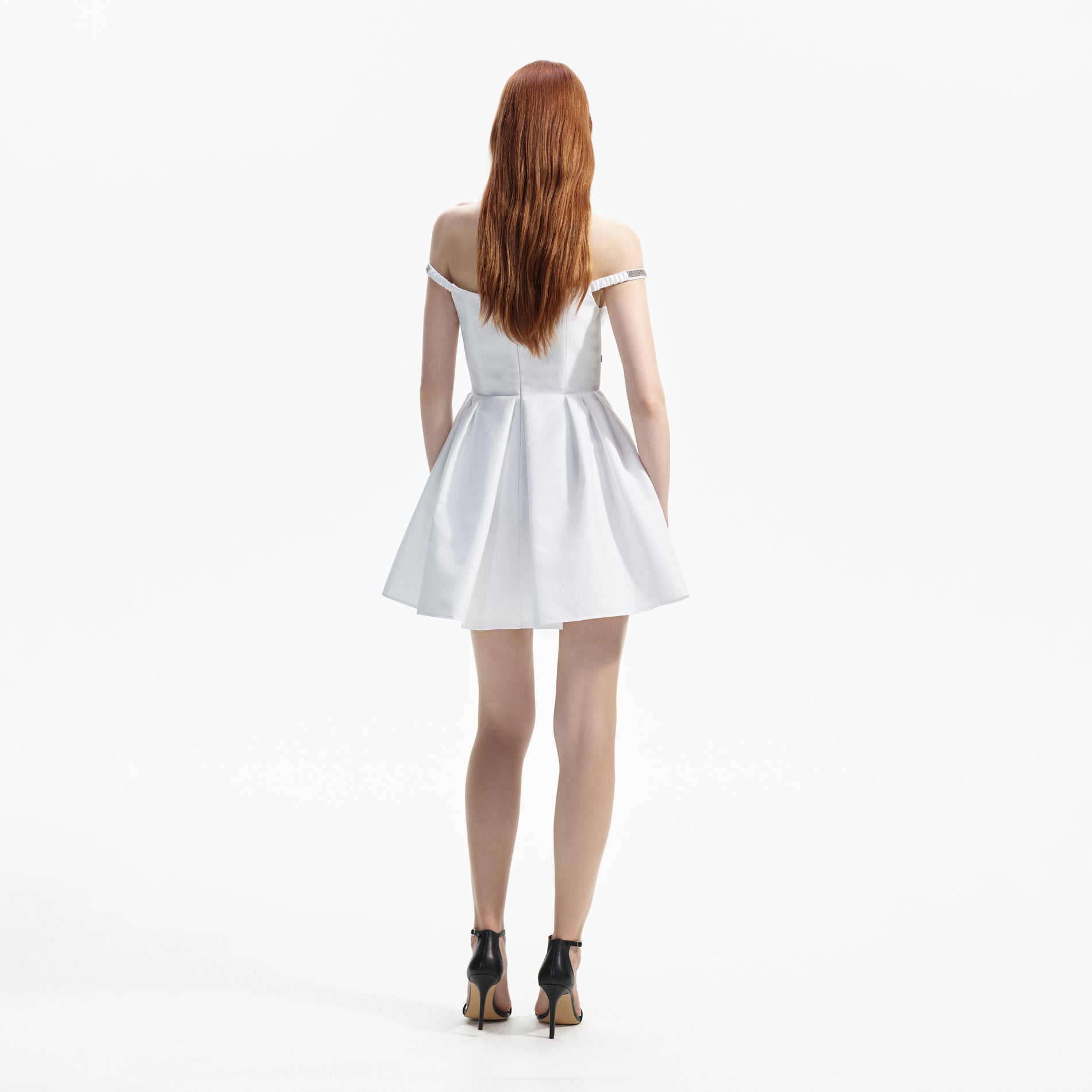Back view of a woman wearing the White Textured Diamante Mini Dress