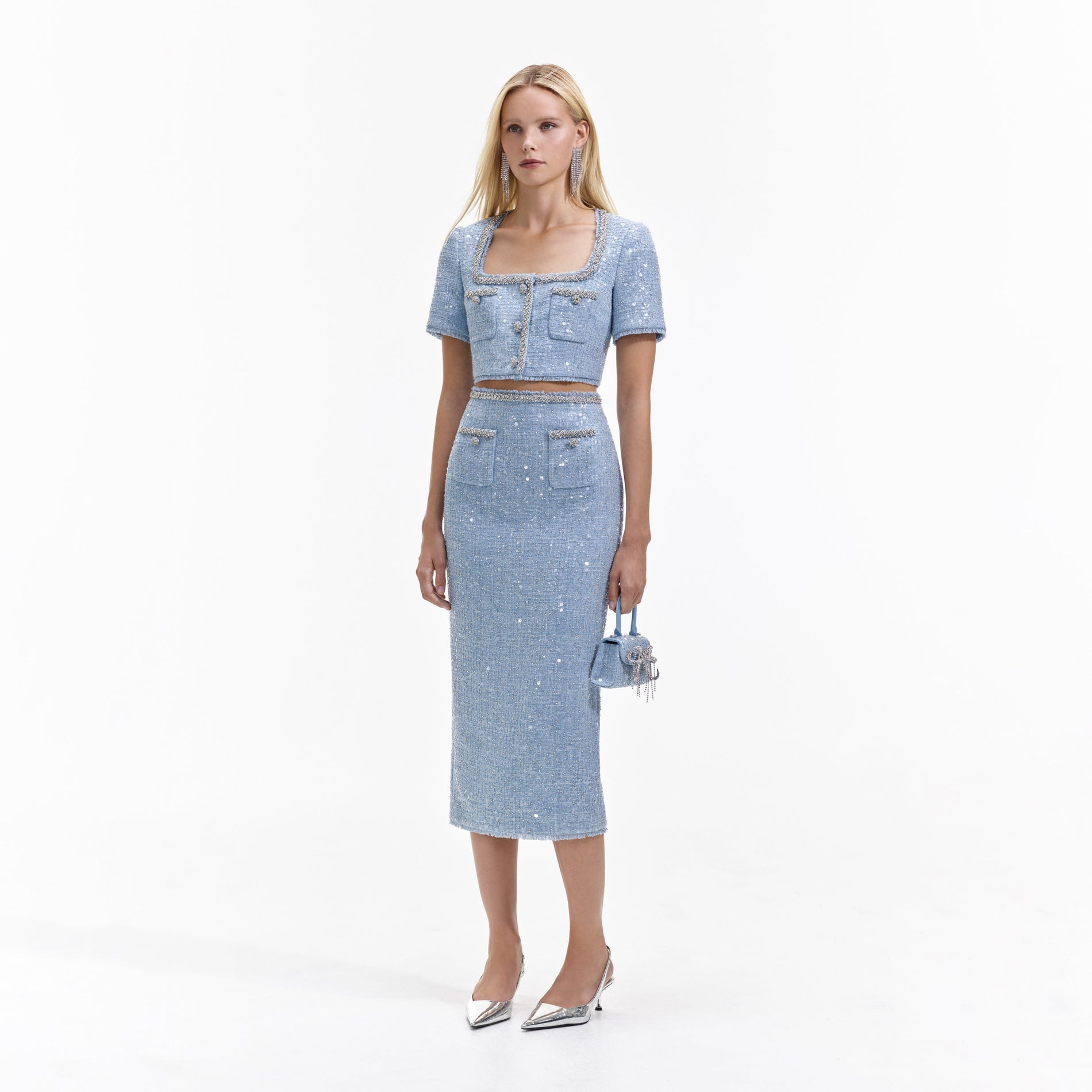 Side view of a woman wearing the Blue Sequin Boucle Midi Skirt
