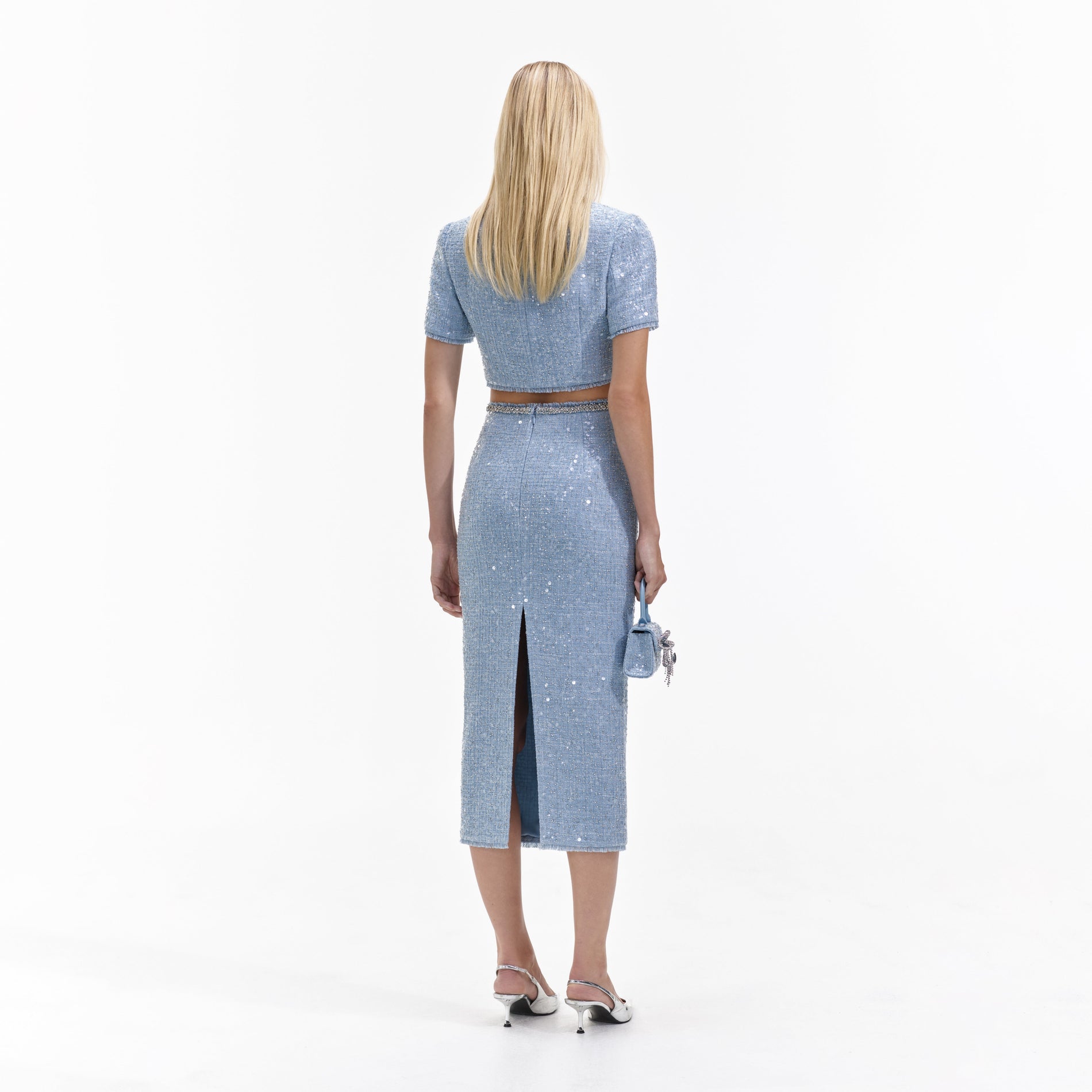 Back view of a woman wearing the Blue Sequin Boucle Midi Skirt