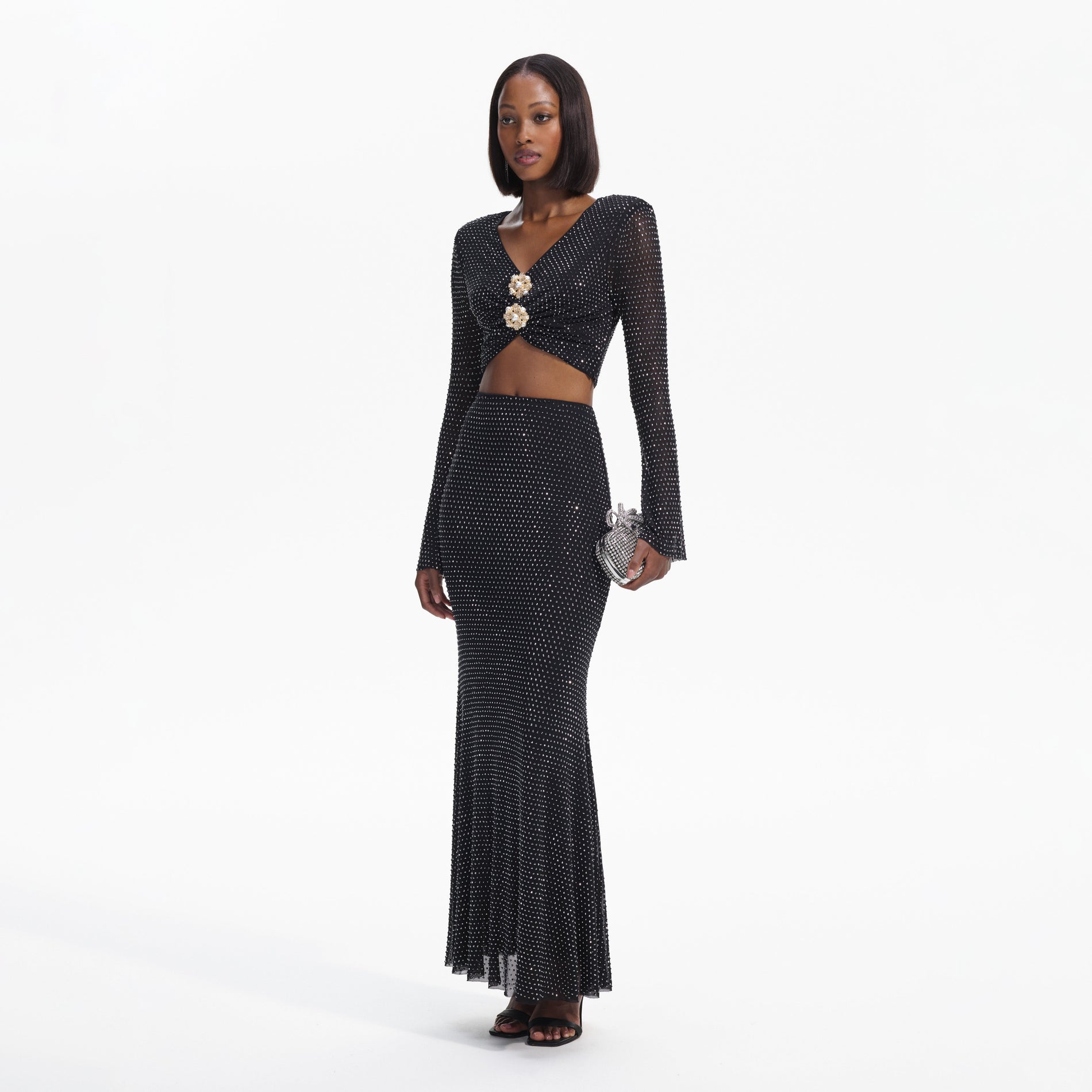 Side view of a woman wearing the Black Rhinestone Maxi Skirt