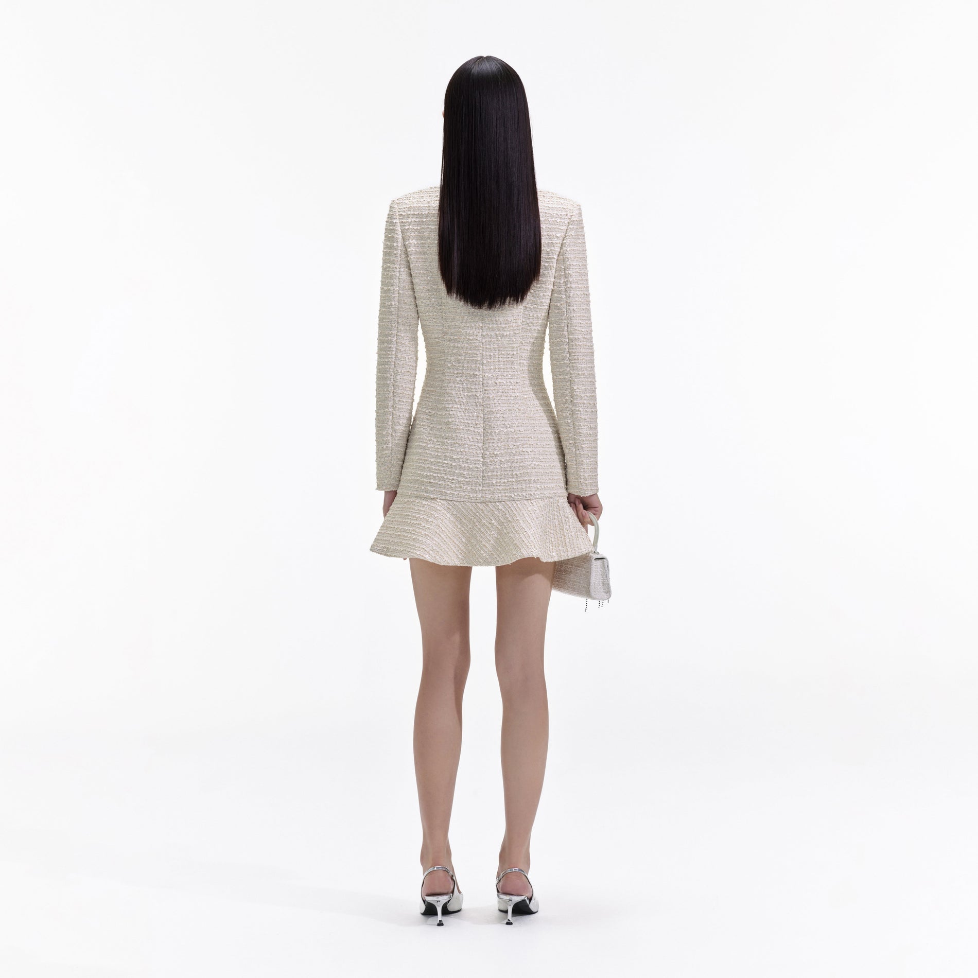 Back view of a woman wearing the Gold Boucle Long Sleeve Mini Dress